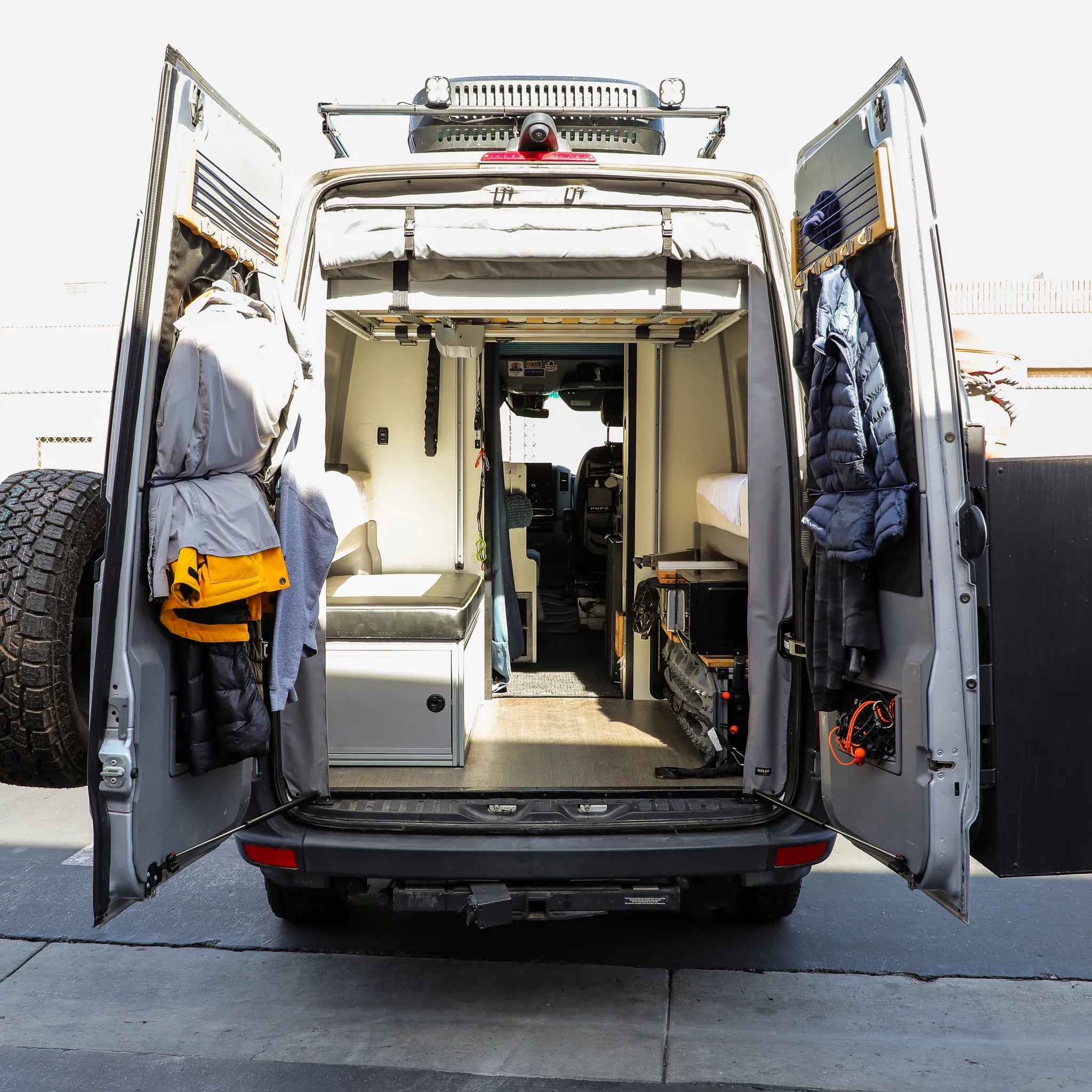 Rear view of a Mercedes Sprinter van with STOP-STAY door safety system installed, doors open to reveal interior.