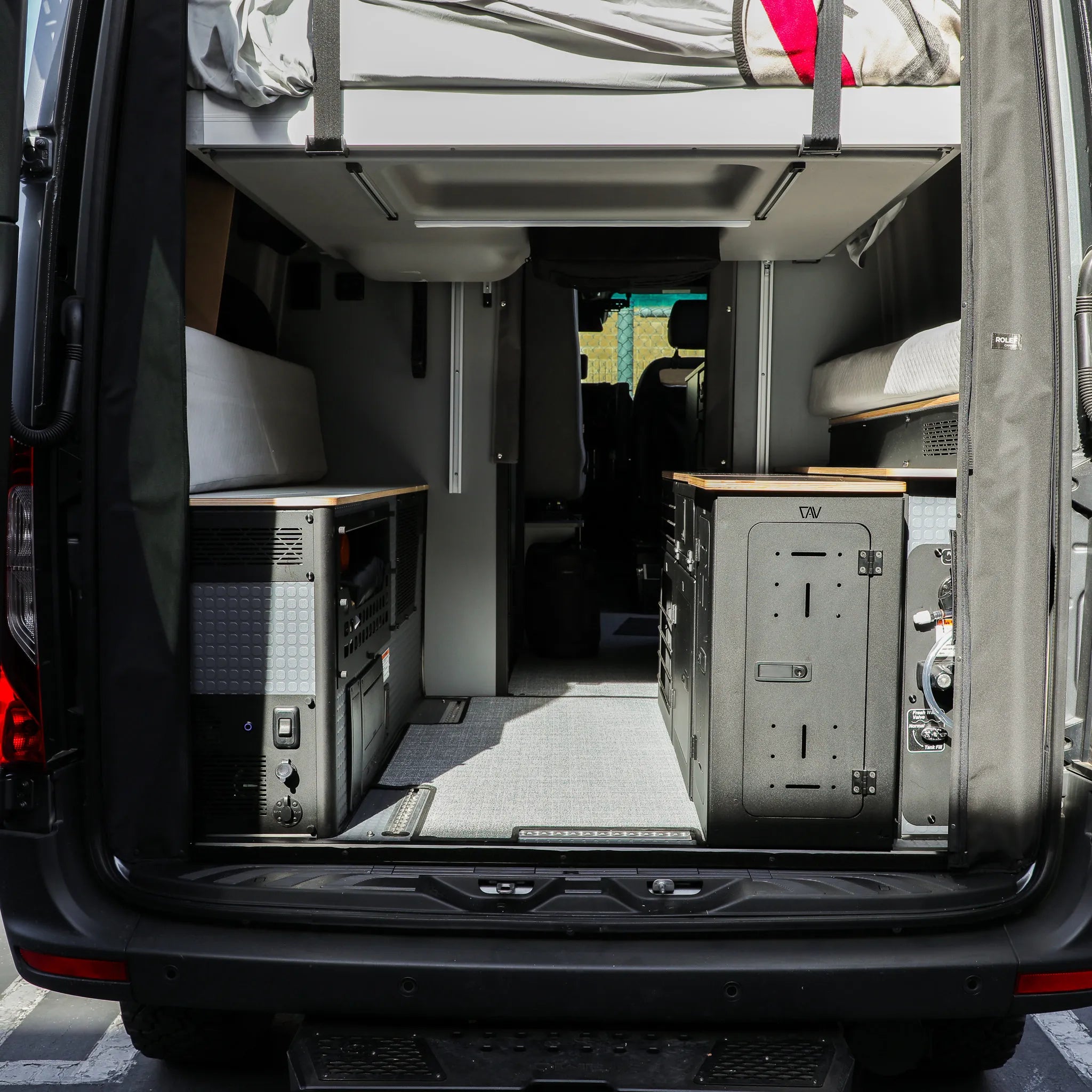 Rear view of GLSS Passenger PRO setup with desk and H2O Box installed in a 2025 Revel van.