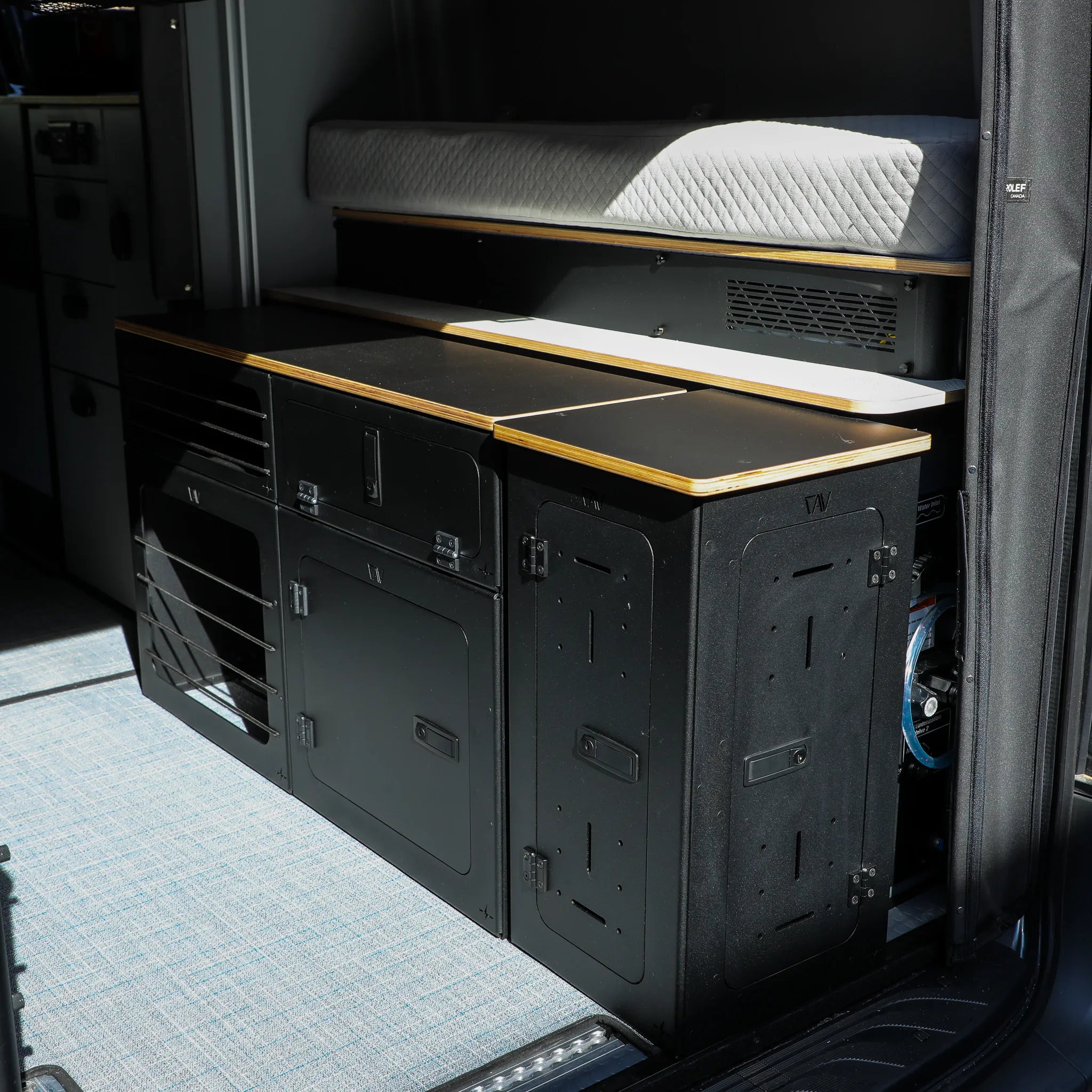 GLSS Passenger PRO with desk and H2O Box installed in a 2025 Revel van interior.