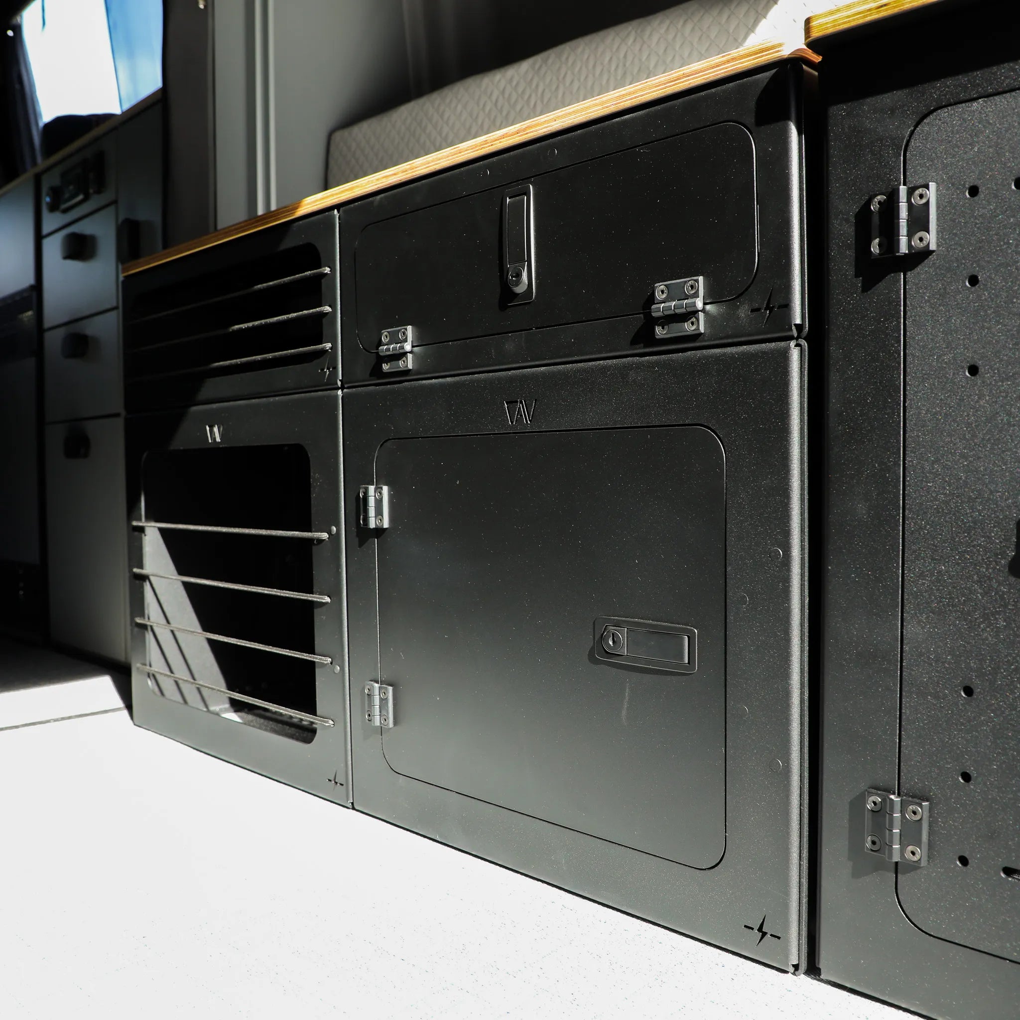 Passenger-side GLSS PRO with integrated desk and H2O Box installed in 2025 Revel van interior.