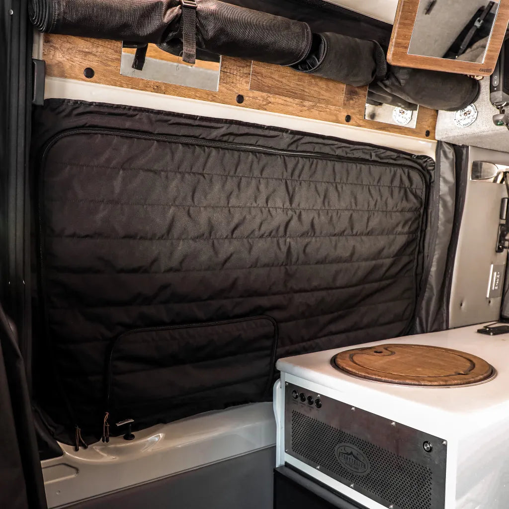 Revel CLIMA-SHADE covering van window above white counter with wood accents
