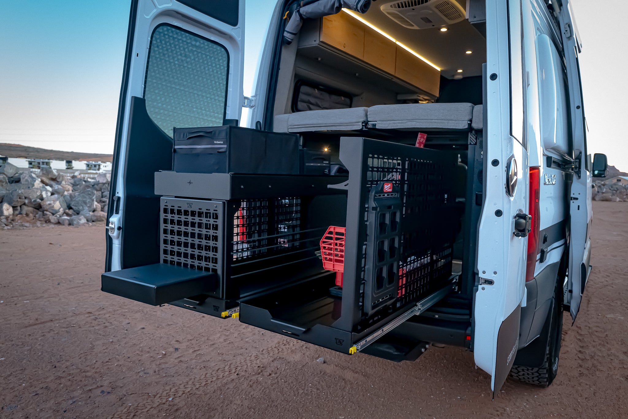 two 48x19 slides in storyteller with gear wall with milwaukee tool kits and second slide with molle and legs stacked tray only bungees