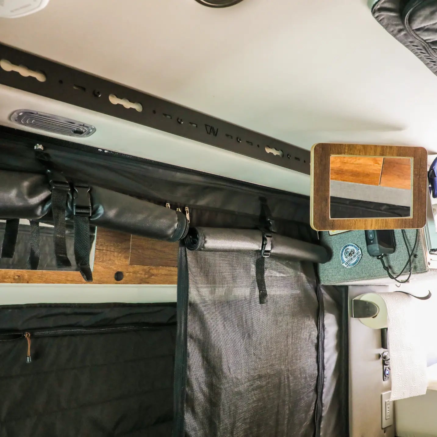 L-Track Pro system installed above sliding rear door in a Storyteller Overland Mode van interior.