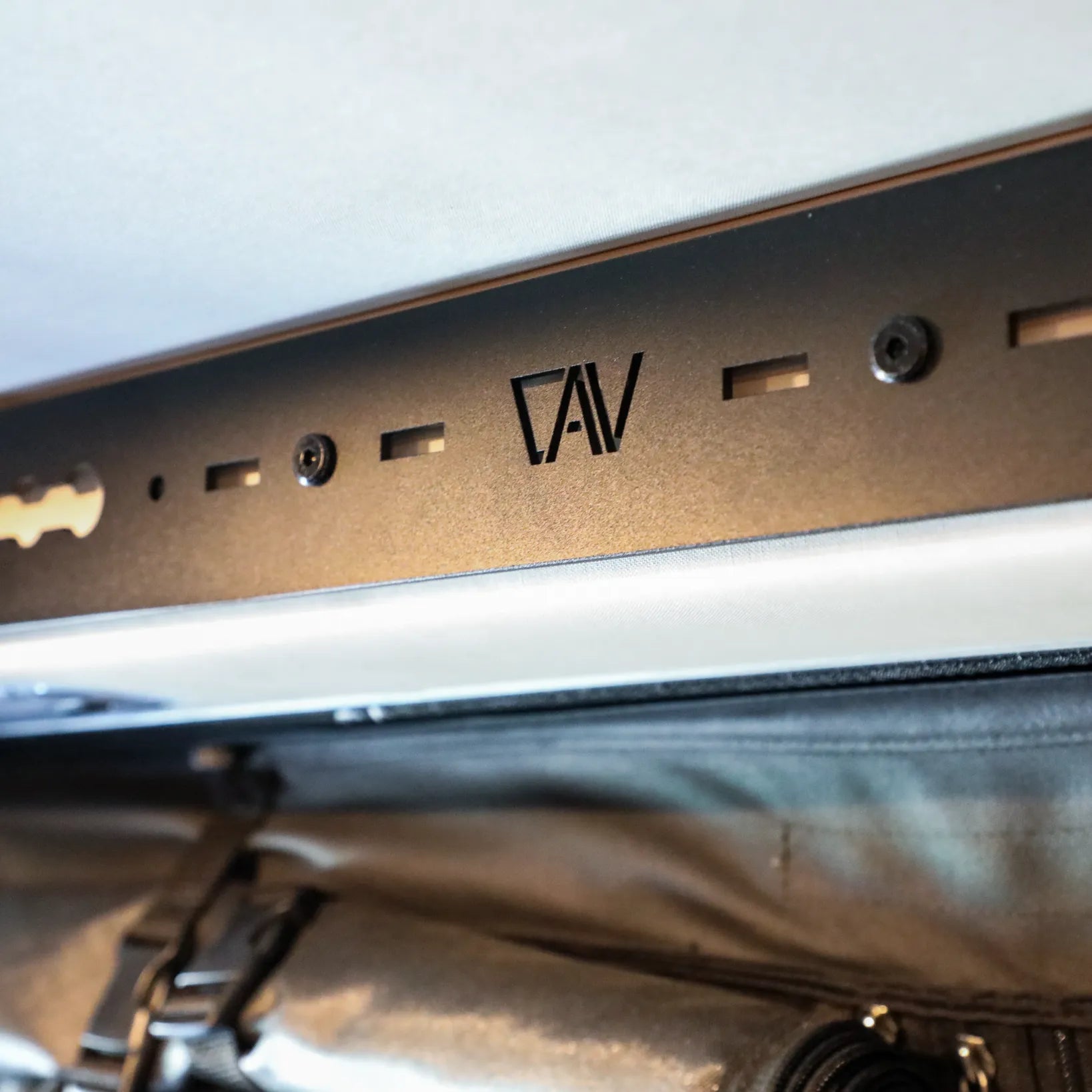CAV L-Track Pro installed above rear door in a Storyteller Overland Mode van interior