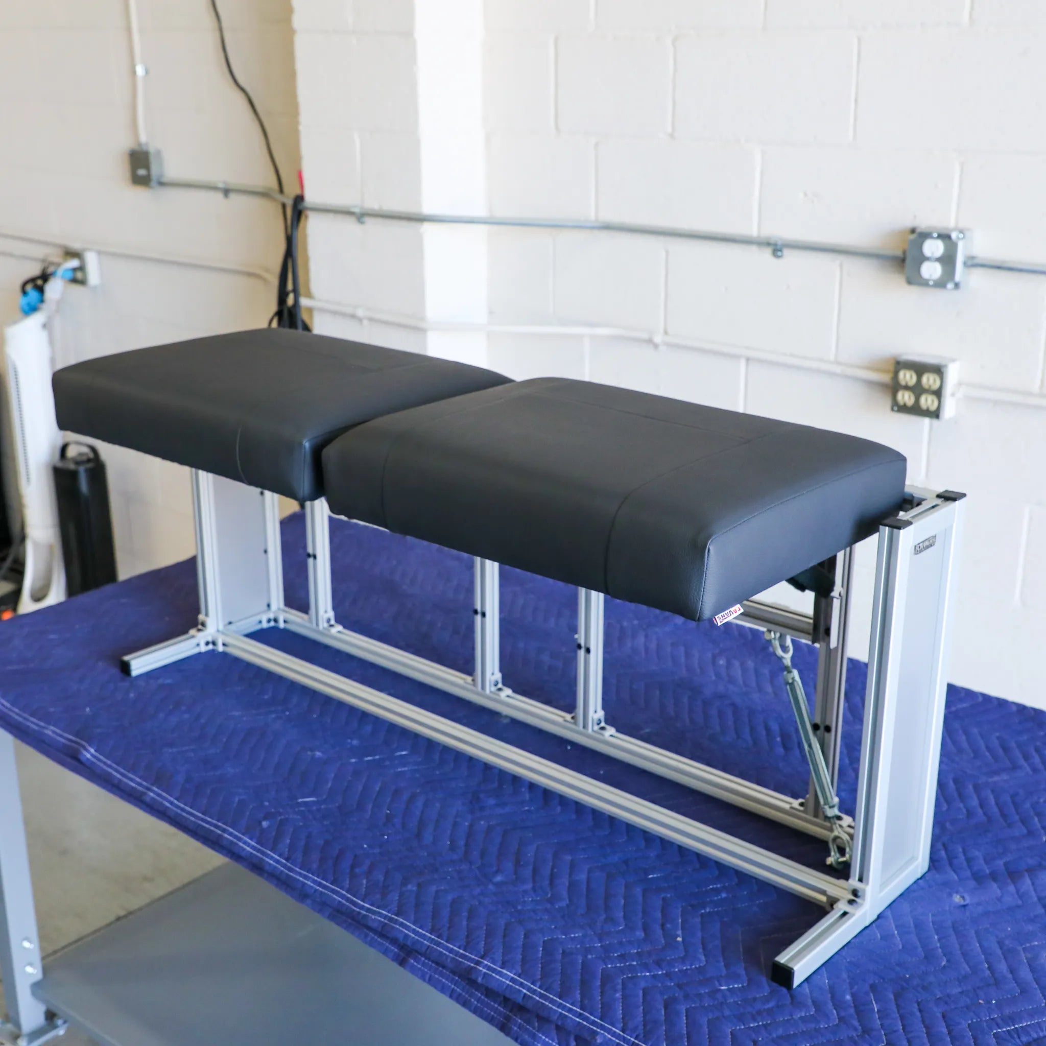 CSS-R countertop seating system for Revel model years 2021 to 2024, seen from the side with a dark cushion and metal frame.