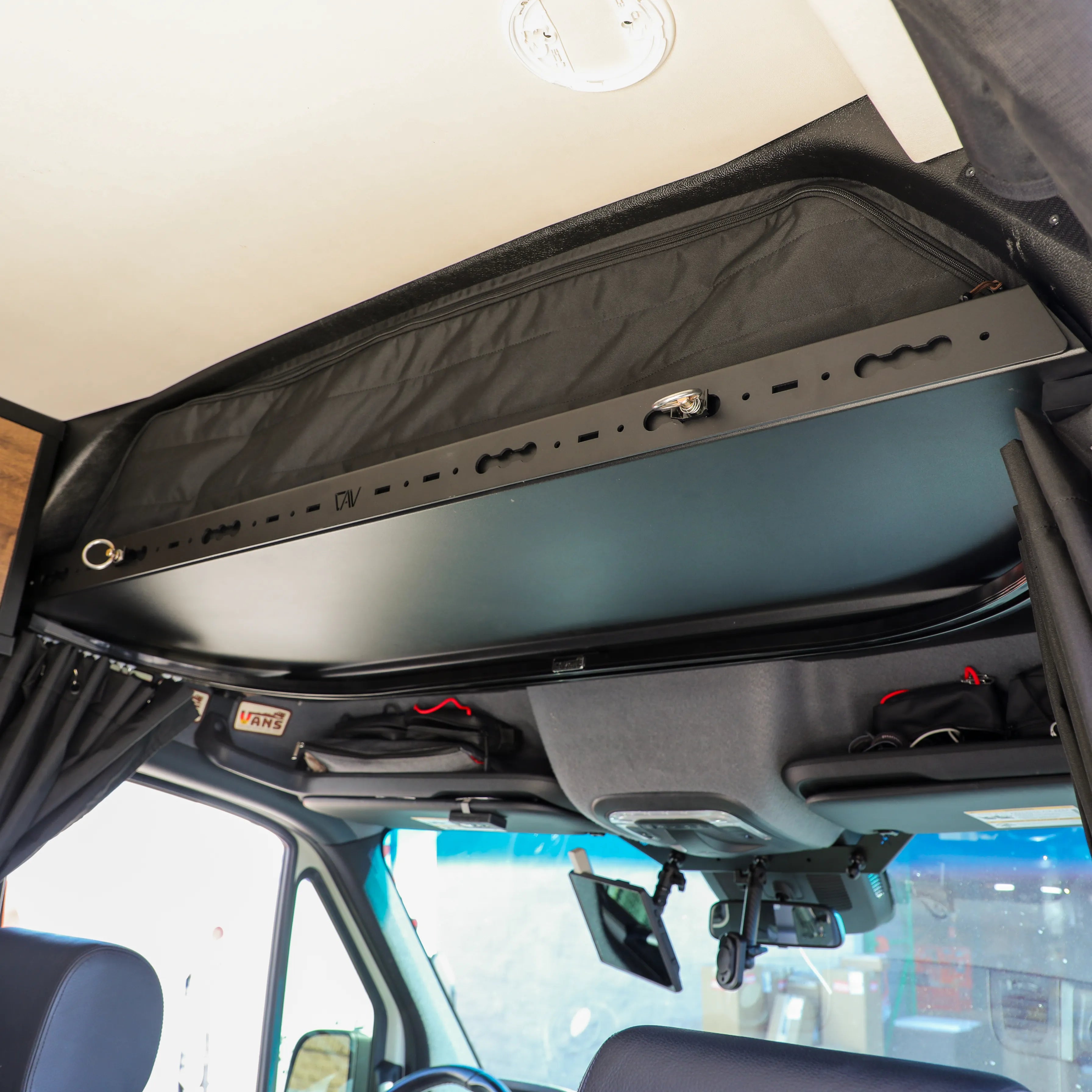 Revel Headliner Shelf Bundle installed above cab area in Storyteller Sprinter van interior.