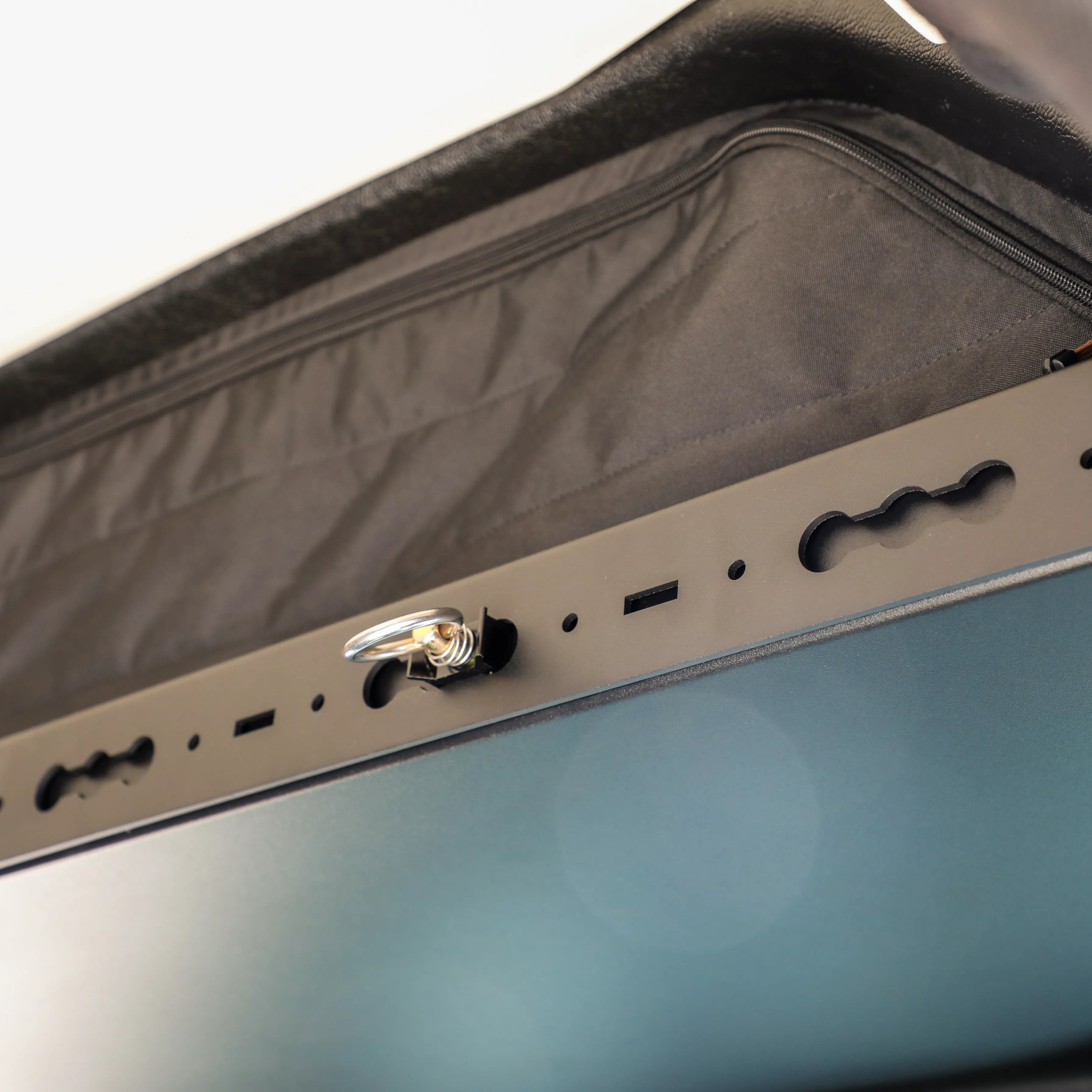 Close-up of GH1 overhead shelf gear trim with mounting points in a van interior