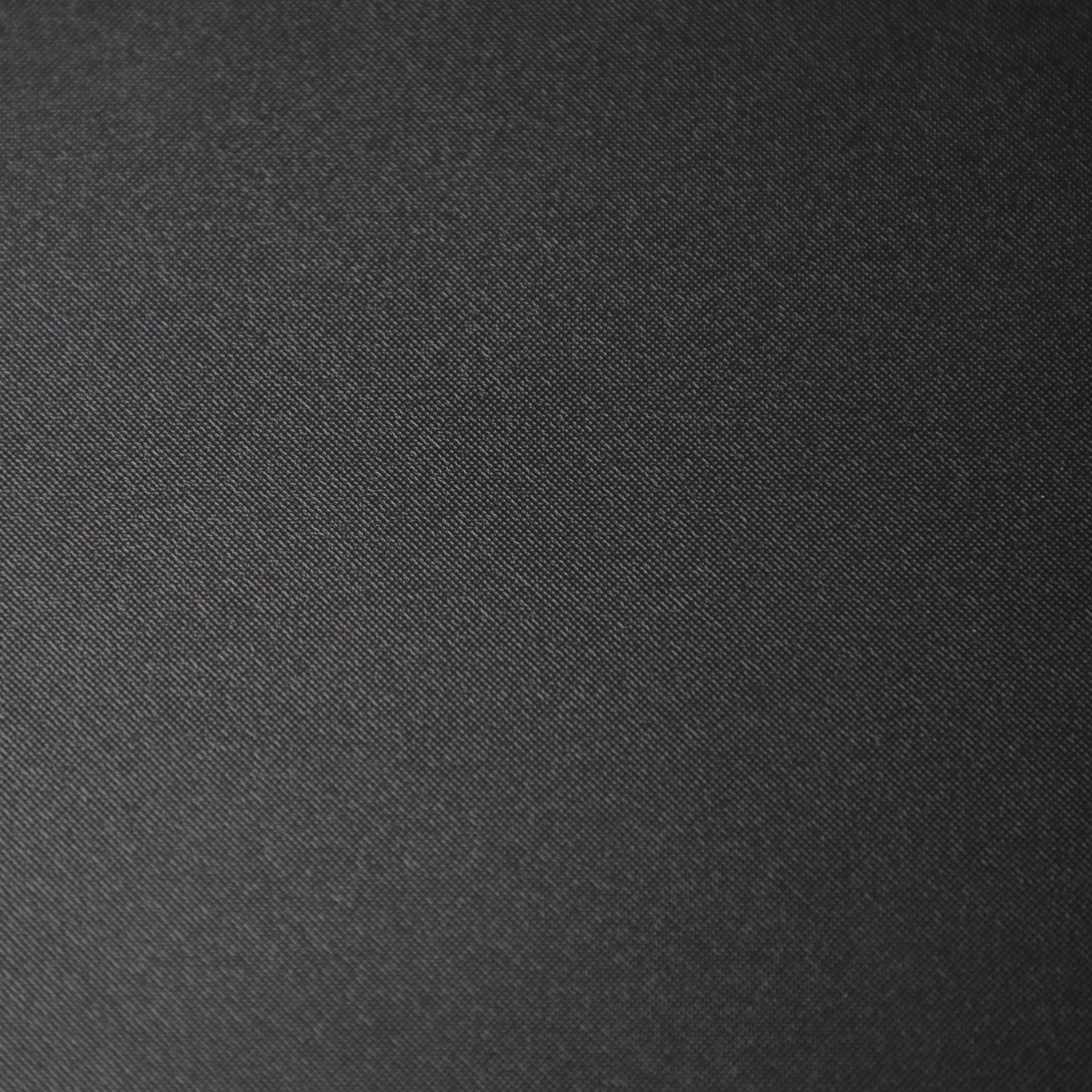 Close-up of the black textured surface of the Jenna 1.0 Folding Table by SHOWROOM.