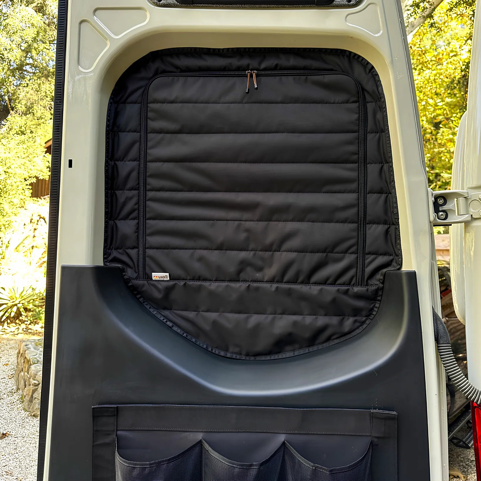 Revel Clima-Shade rear door window cover installed inside a van door