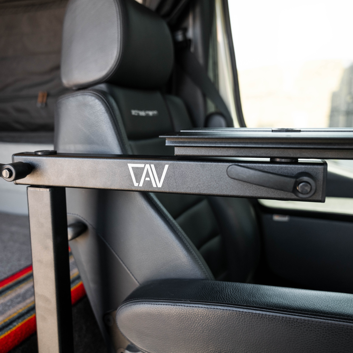 CAV Canyon Table Leg System mounted beside van seat with swivel arm extended