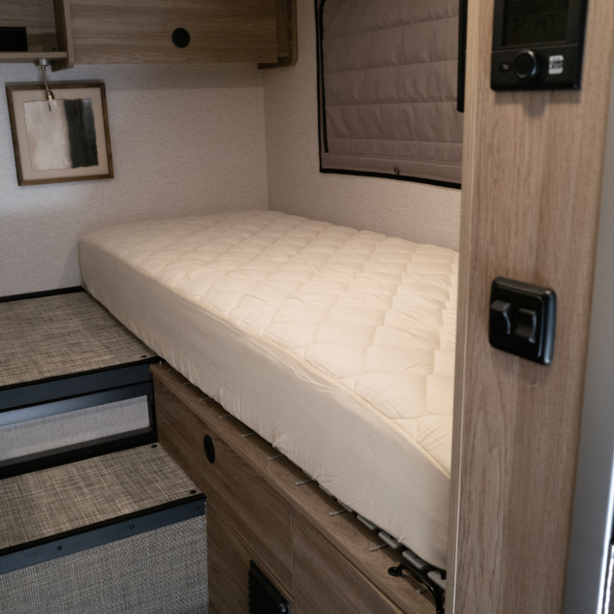 Ultra Luxe mattress in Winnebago Ekko van with wood cabinetry and side window shade