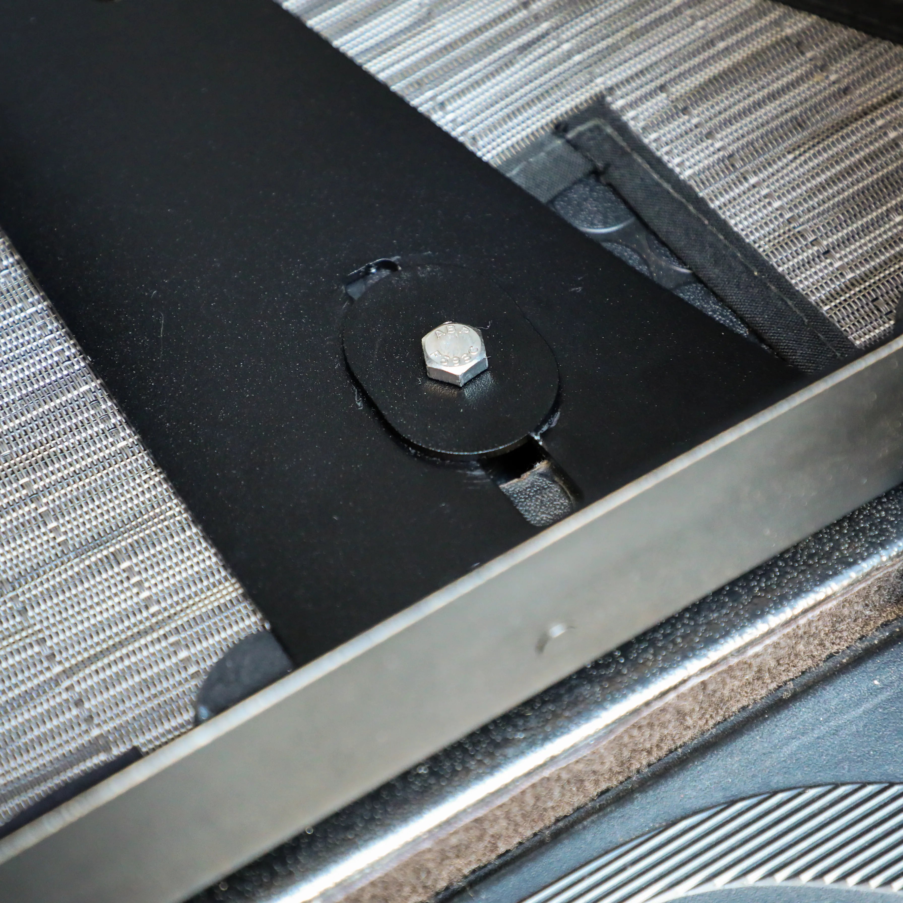 Close-up of mounting hardware on GLSS Passenger PRO seat inside a van interior.