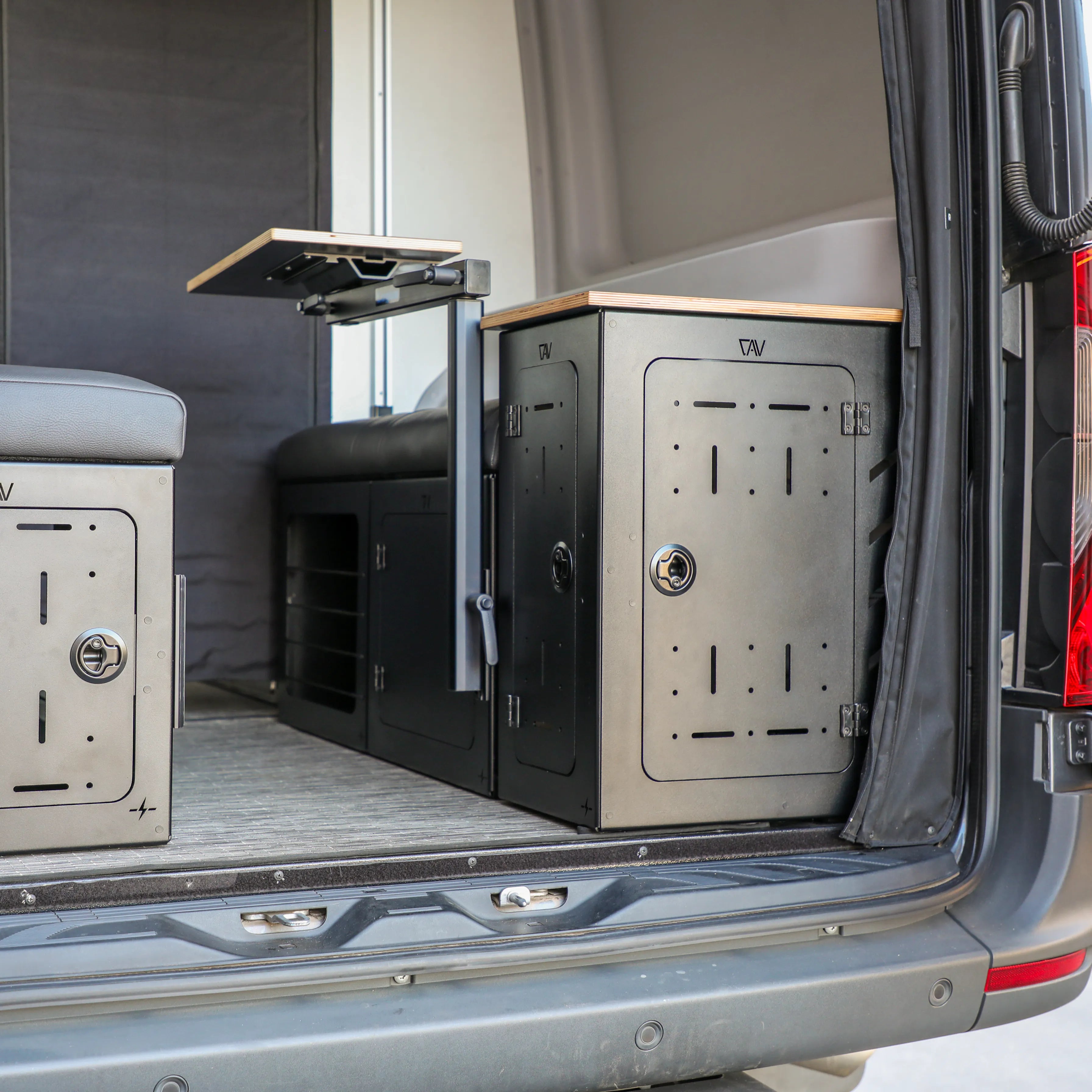 GLSS PRO storage system set by TAV installed in van cargo area with seat and fold-out table visible