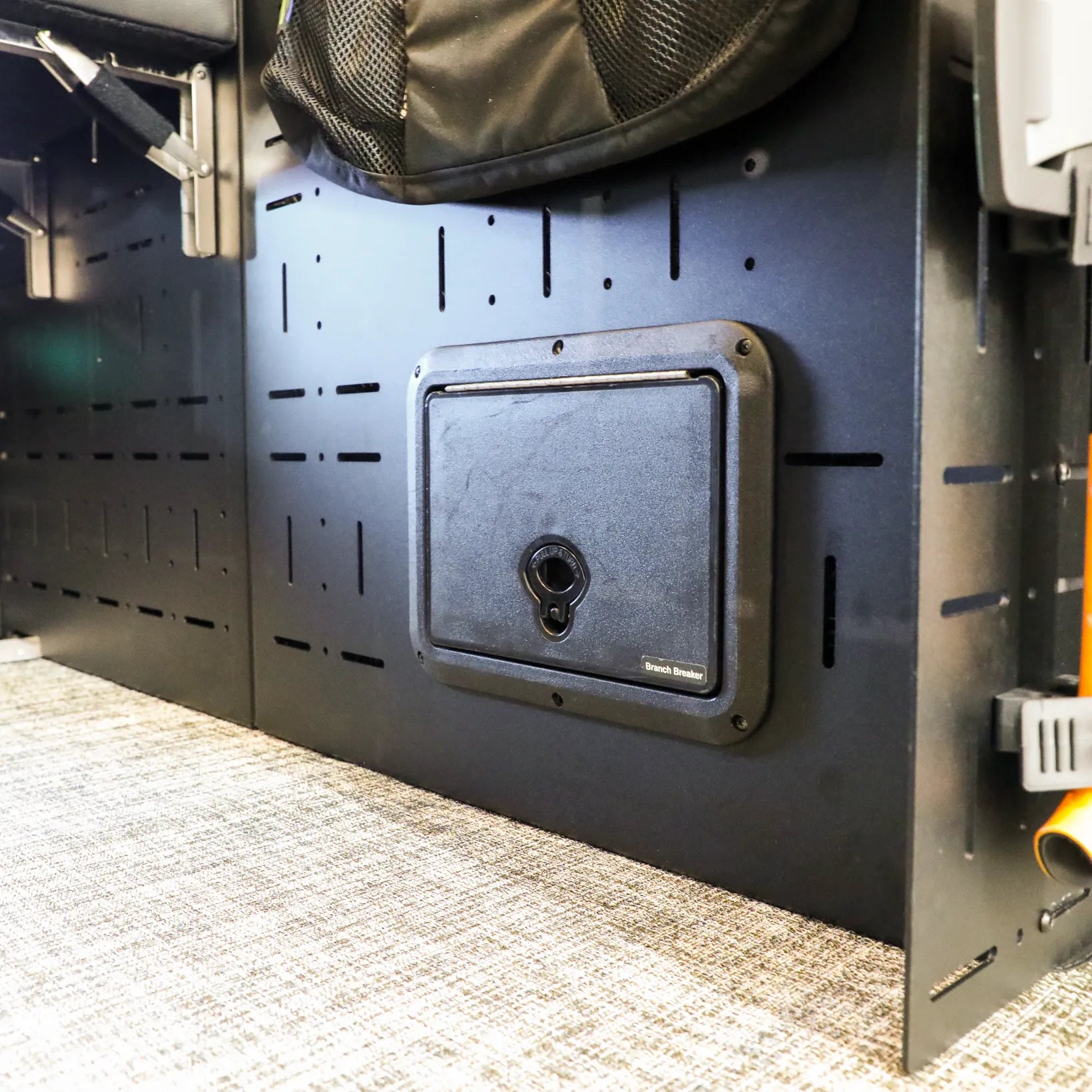 Passenger Gear Wall Pro by Storyteller Overland installed in van interior with mounted storage panel