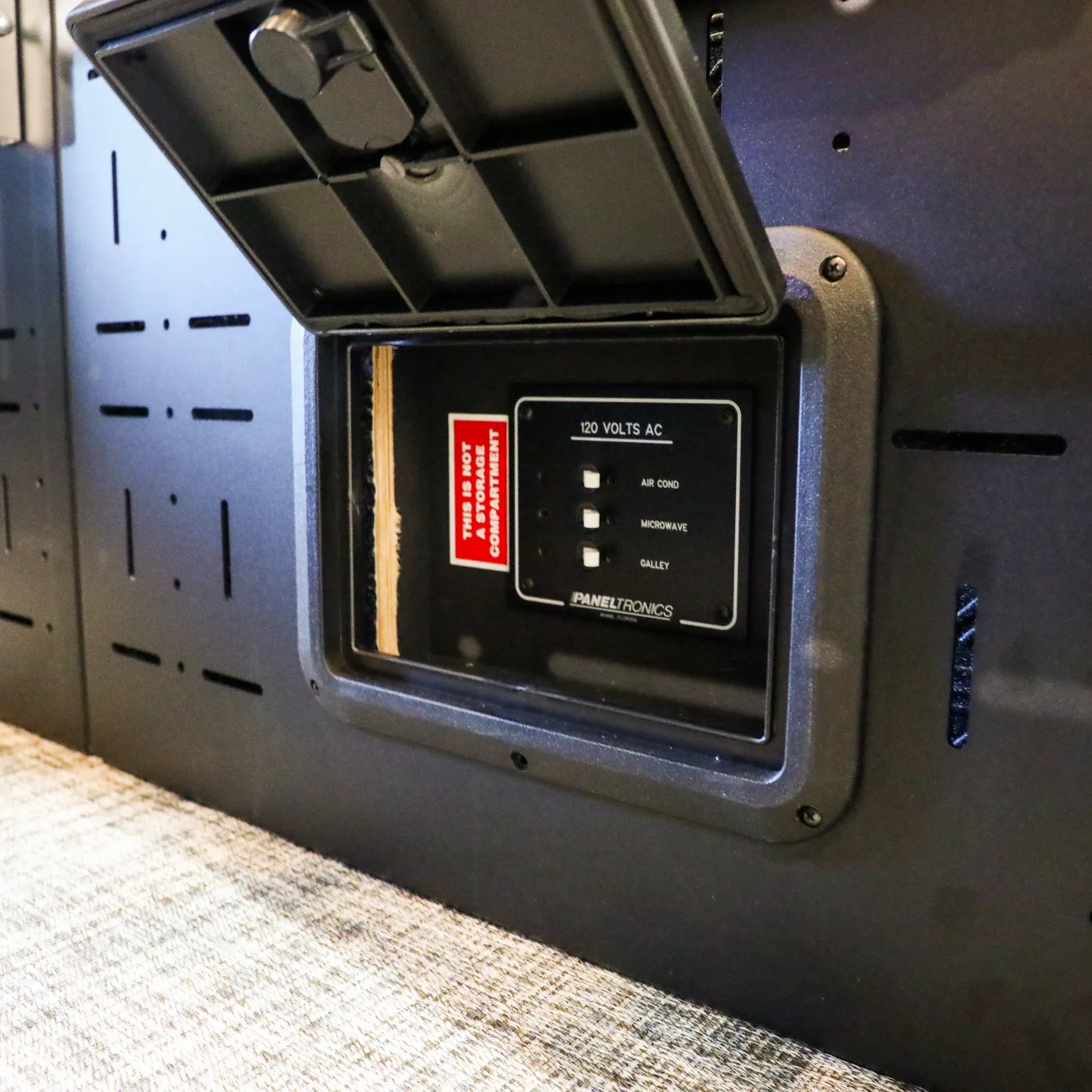 Close-up of RAM electronics panel inside Passenger Gear Wall Pro for Storyteller Overland van