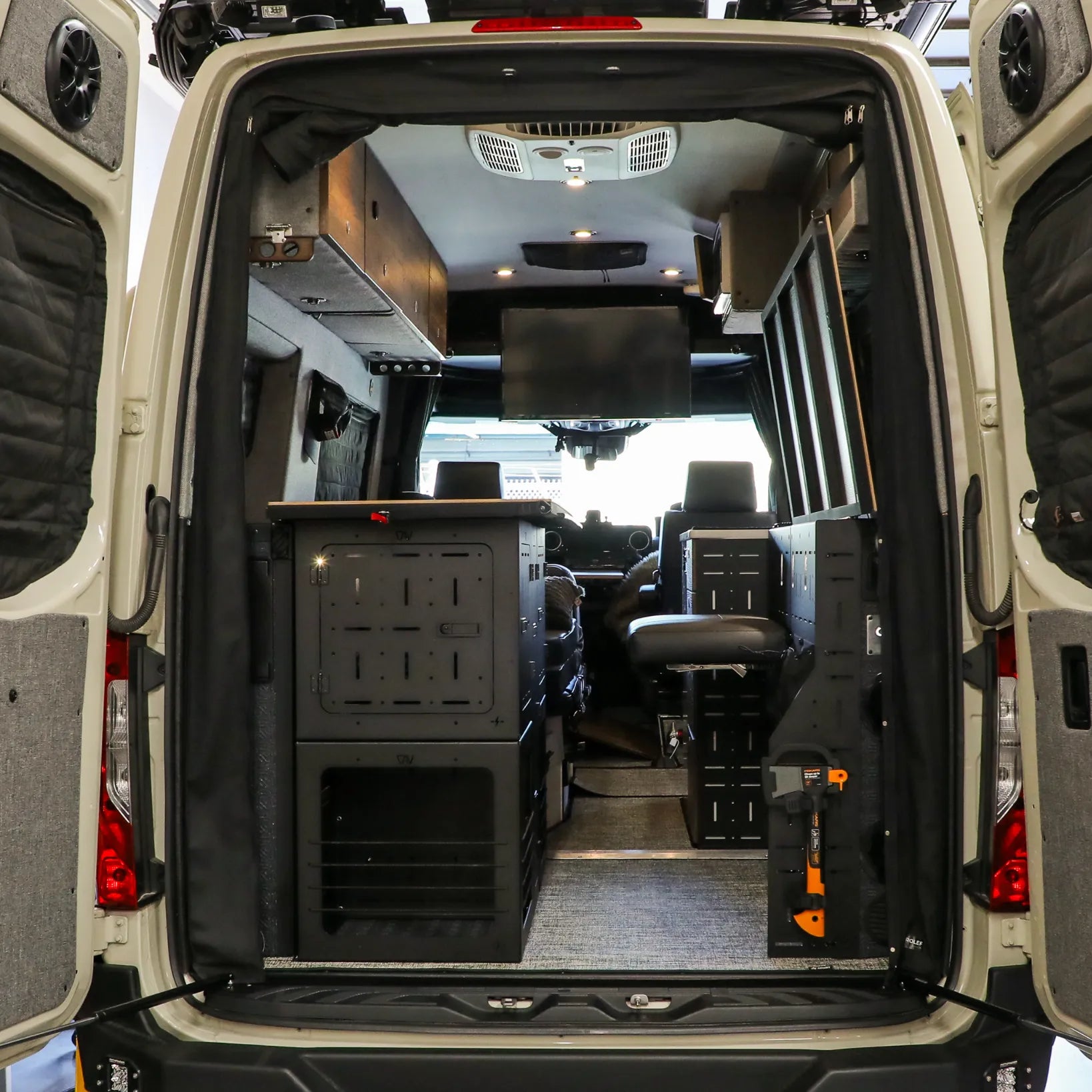 Rear view of Storyteller Overland van with Passenger Gear Wall Pro and storage system.
