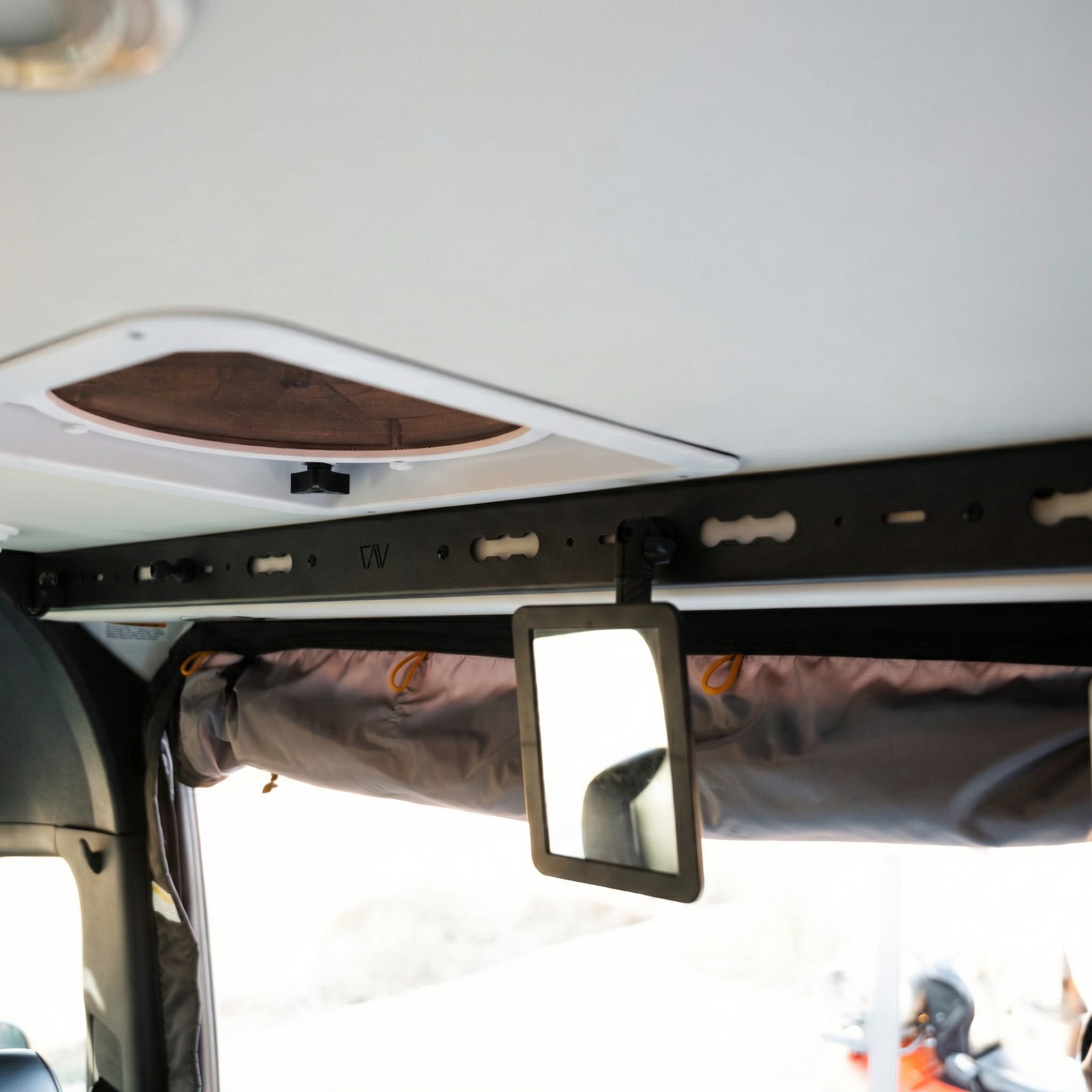 L-Track PRO system installed above sliding door in a Storyteller Overland van