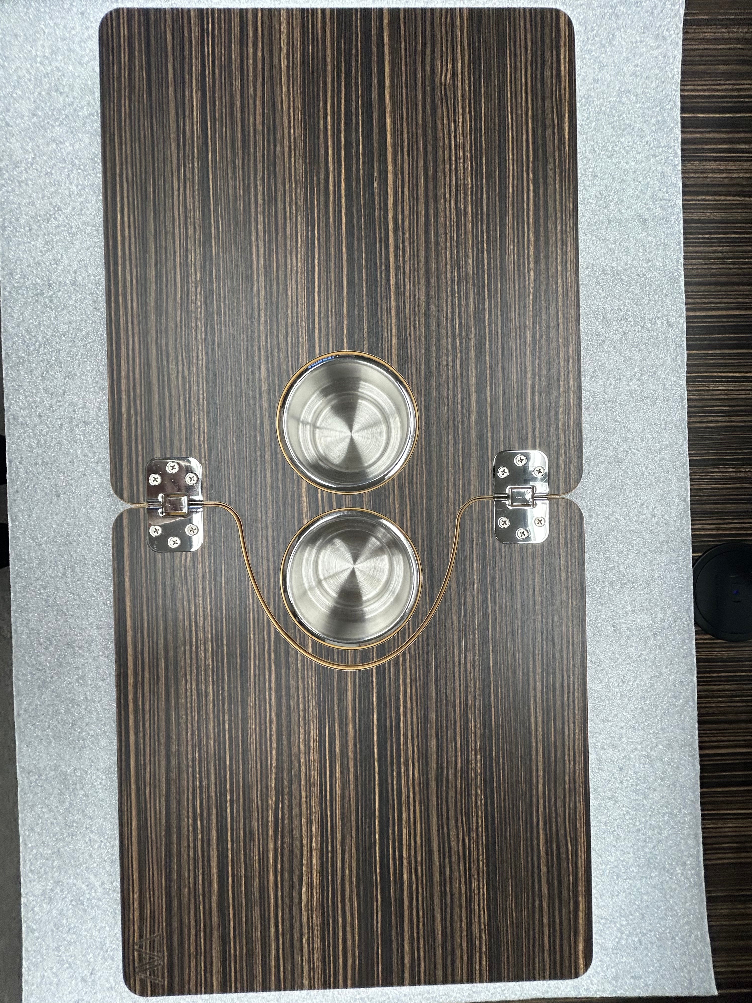 The Jenna 2.0 folding table top by Revel with dark wood grain finish and two built-in cup holders.