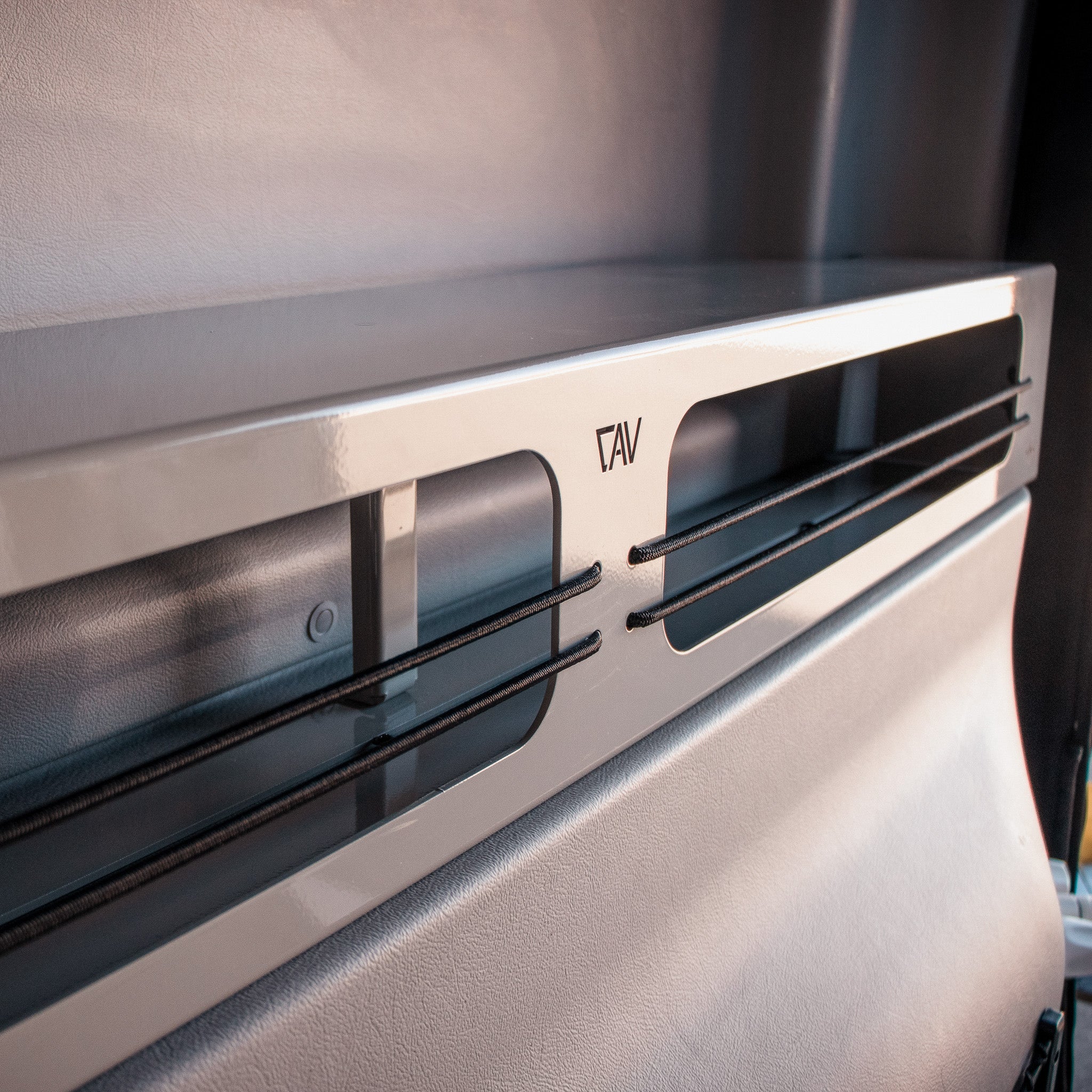 CAV metal shelf mounted inside a van with sleek, modern design.