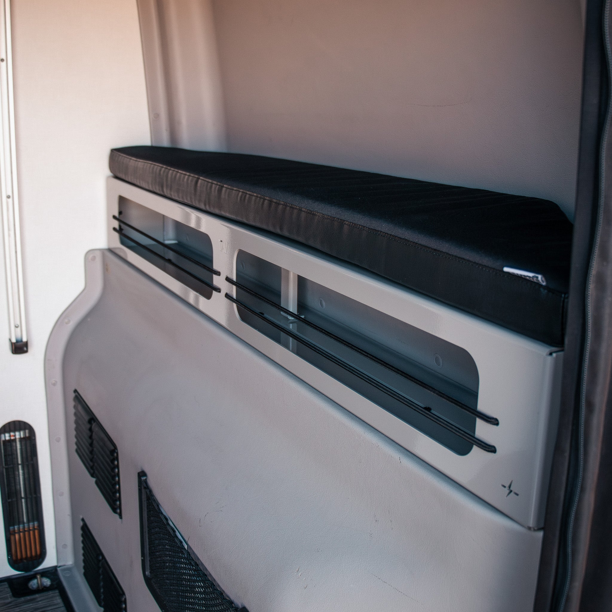 Revel 2-inch Bed Riser Pro Bed Bolsters installed in a van interior with black cushion top