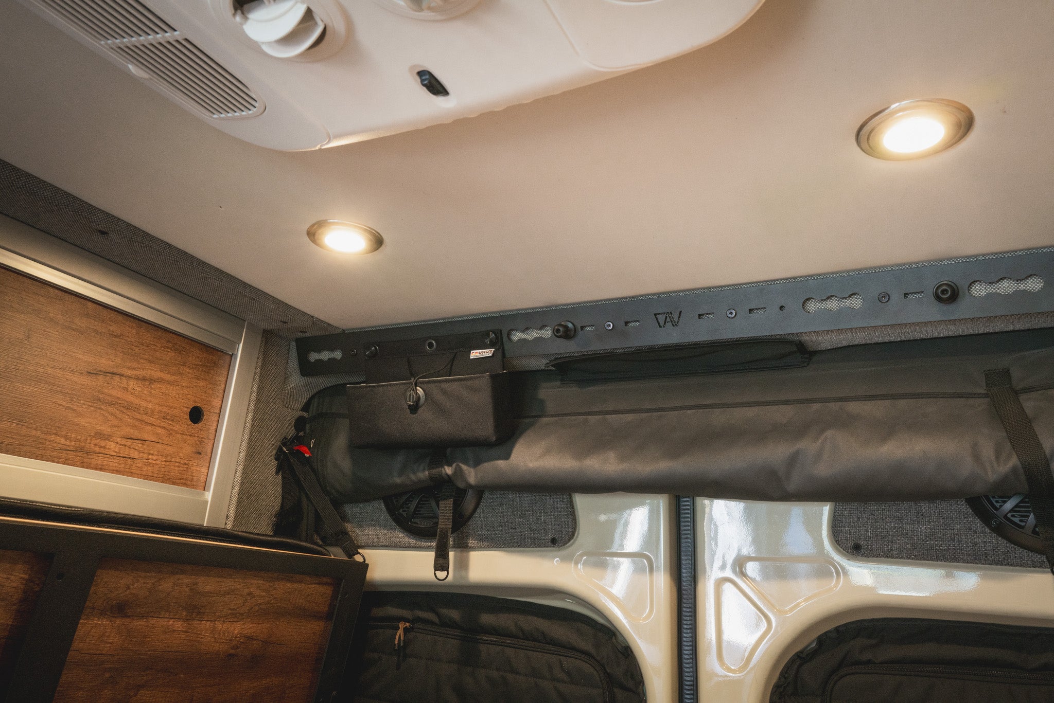 L-Track Pro installed above rear doors in Storyteller Overland Mode van interior ceiling.