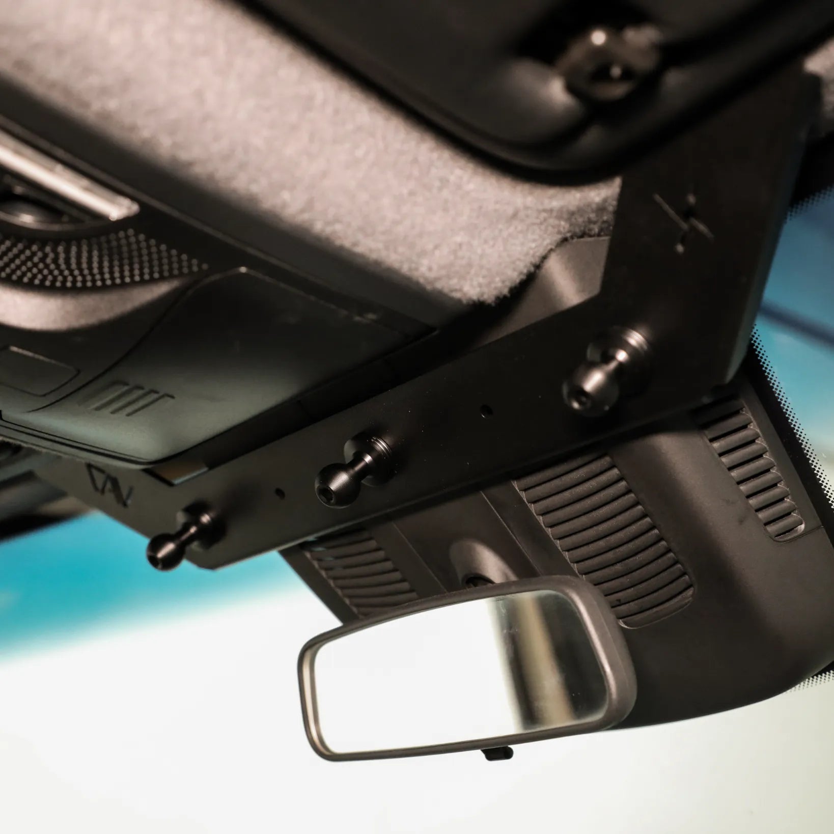 Revel NAV-Mount mounting system installed above the vans rearview mirror.