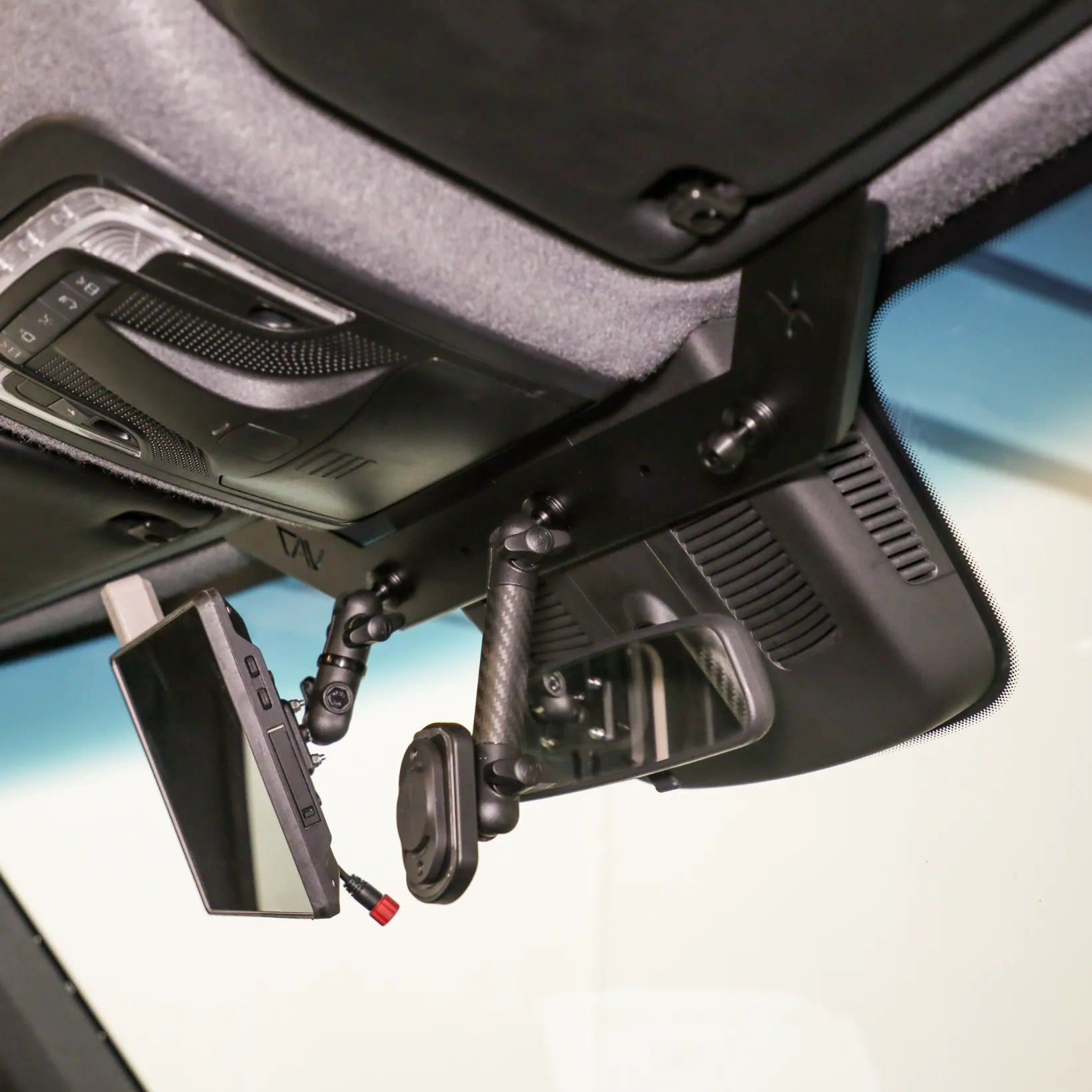 NAV-Mount mounting system attached to ceiling of van cockpit with electronics and monitor arm fixed in place