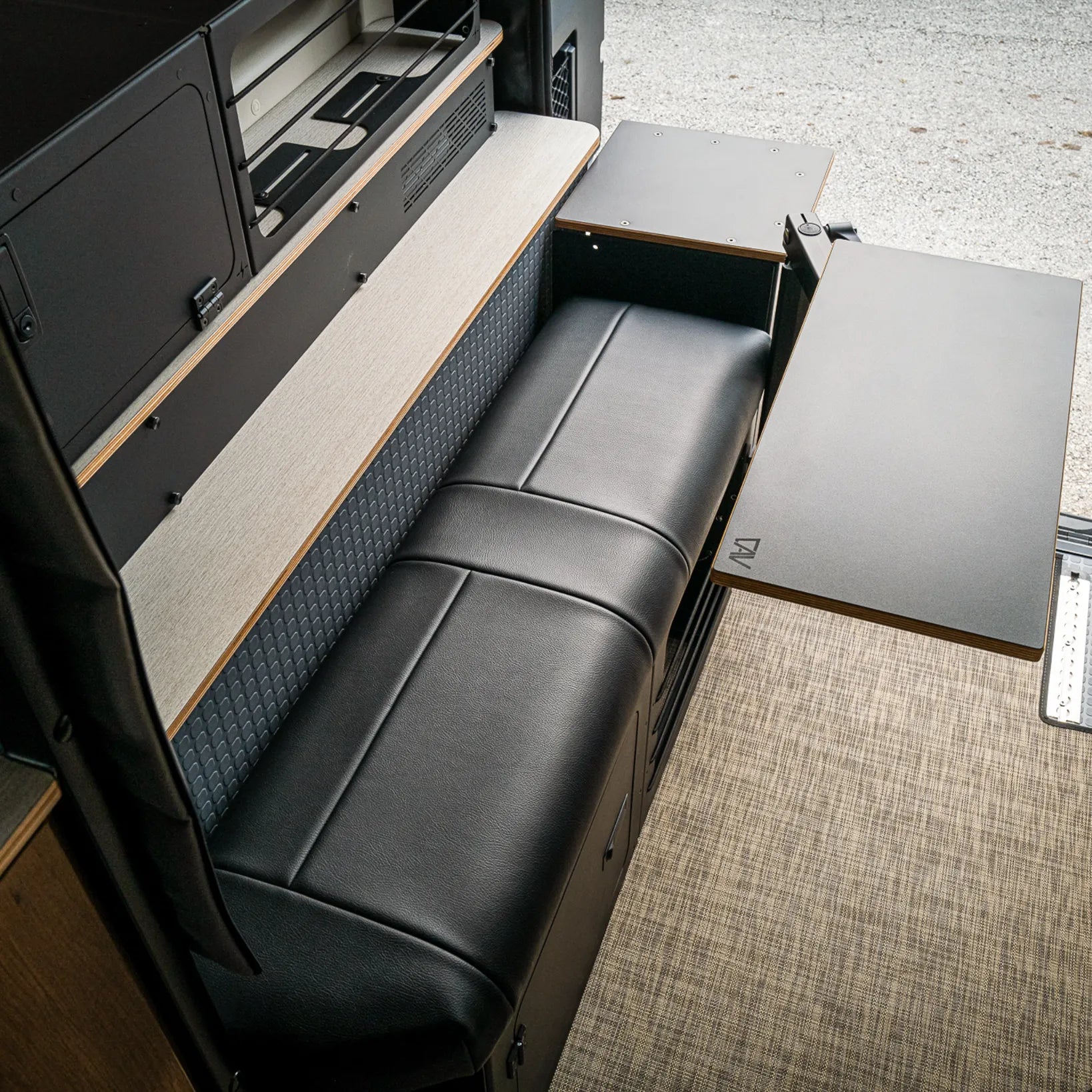 GLSS Passenger PRO seat and H2O box setup in a Revel van interior with extended table open