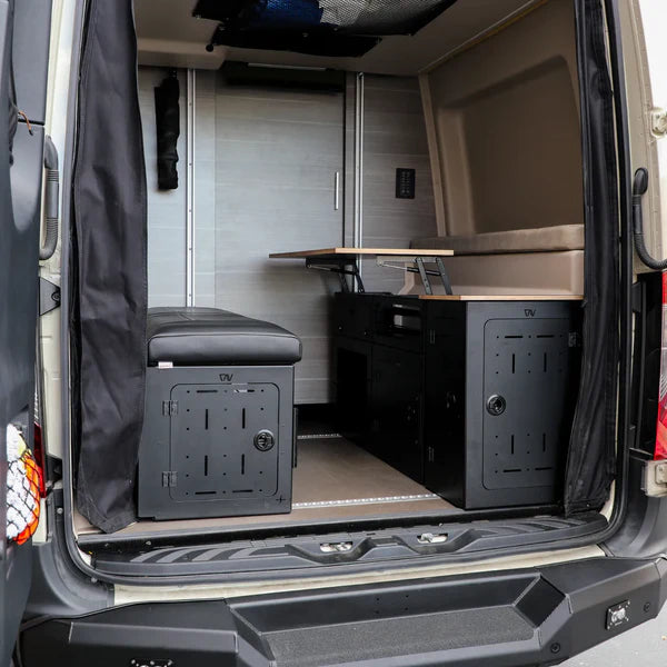 GLSS PRO storage system set installed in the rear of a converted van with bench and table setup
