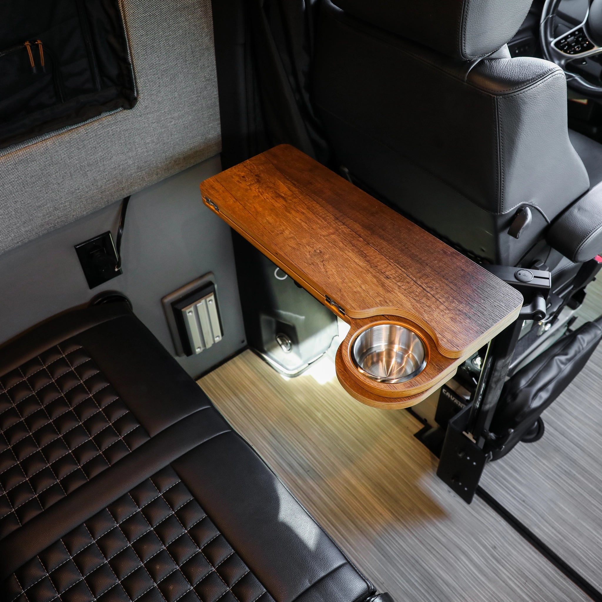 Solo Folding Table Top with cup holder mounted beside van seat in modern interior