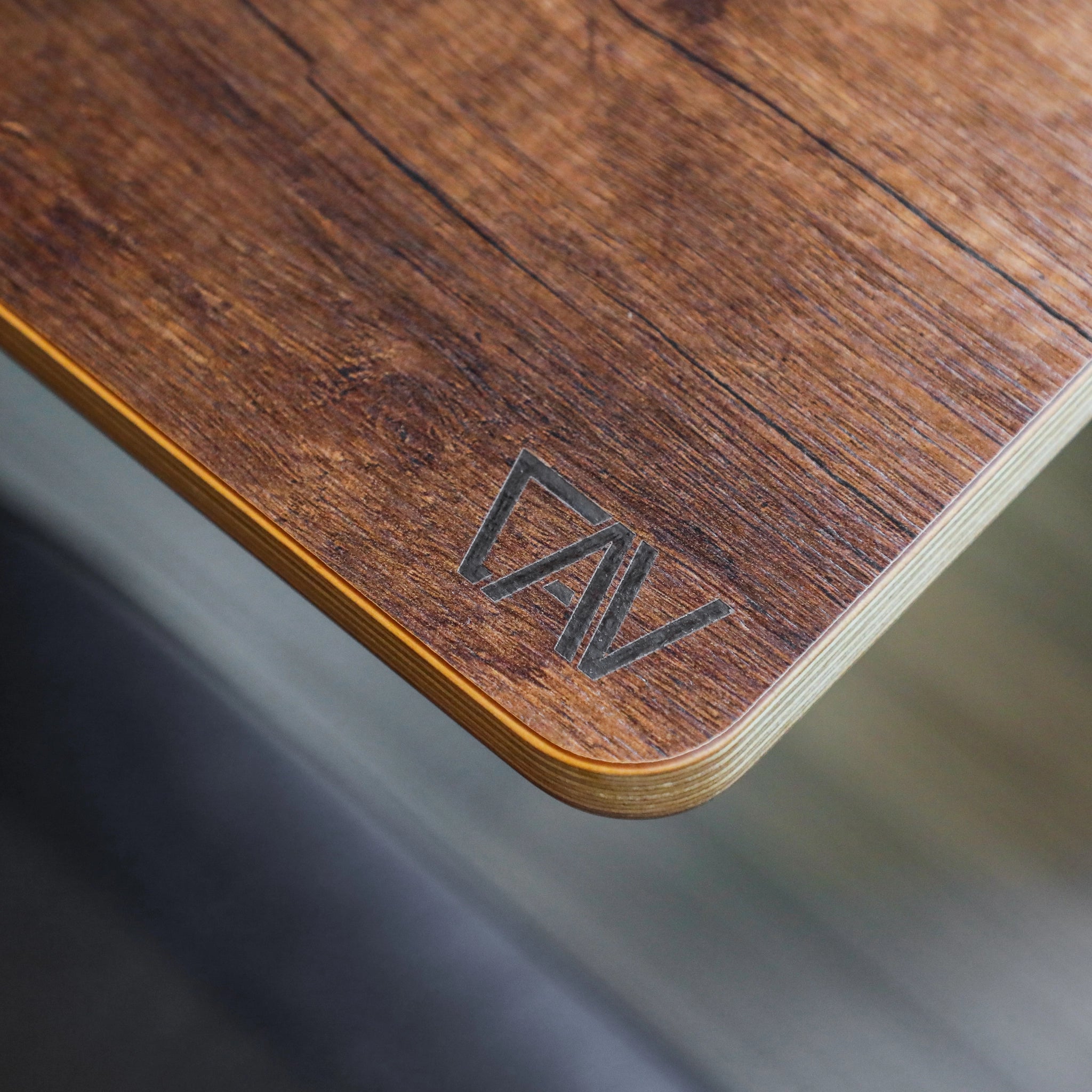 Close-up of CAV Solo Folding Table Top with wood grain finish inside a van