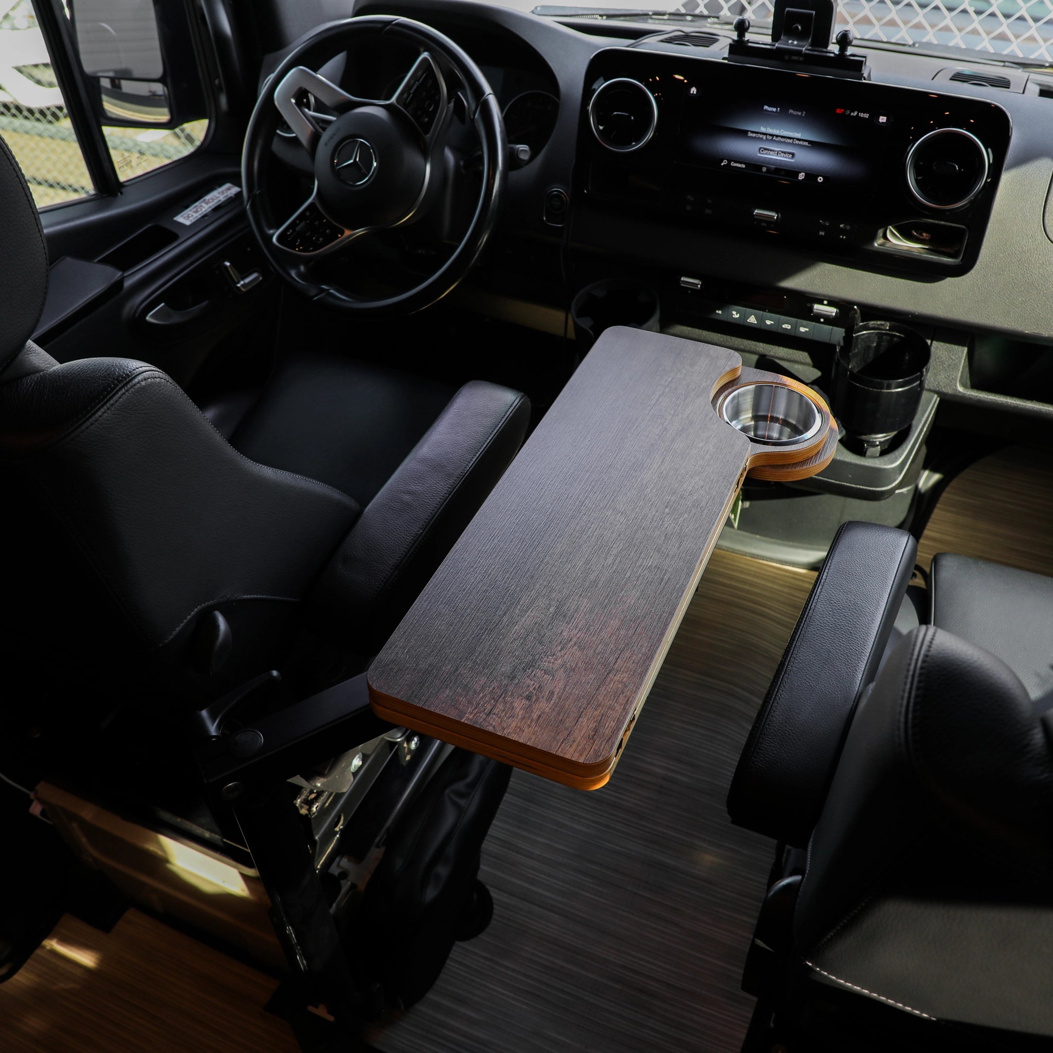 Solo Folding Table Top set up between front seats in a van cockpit with cup holder visible.