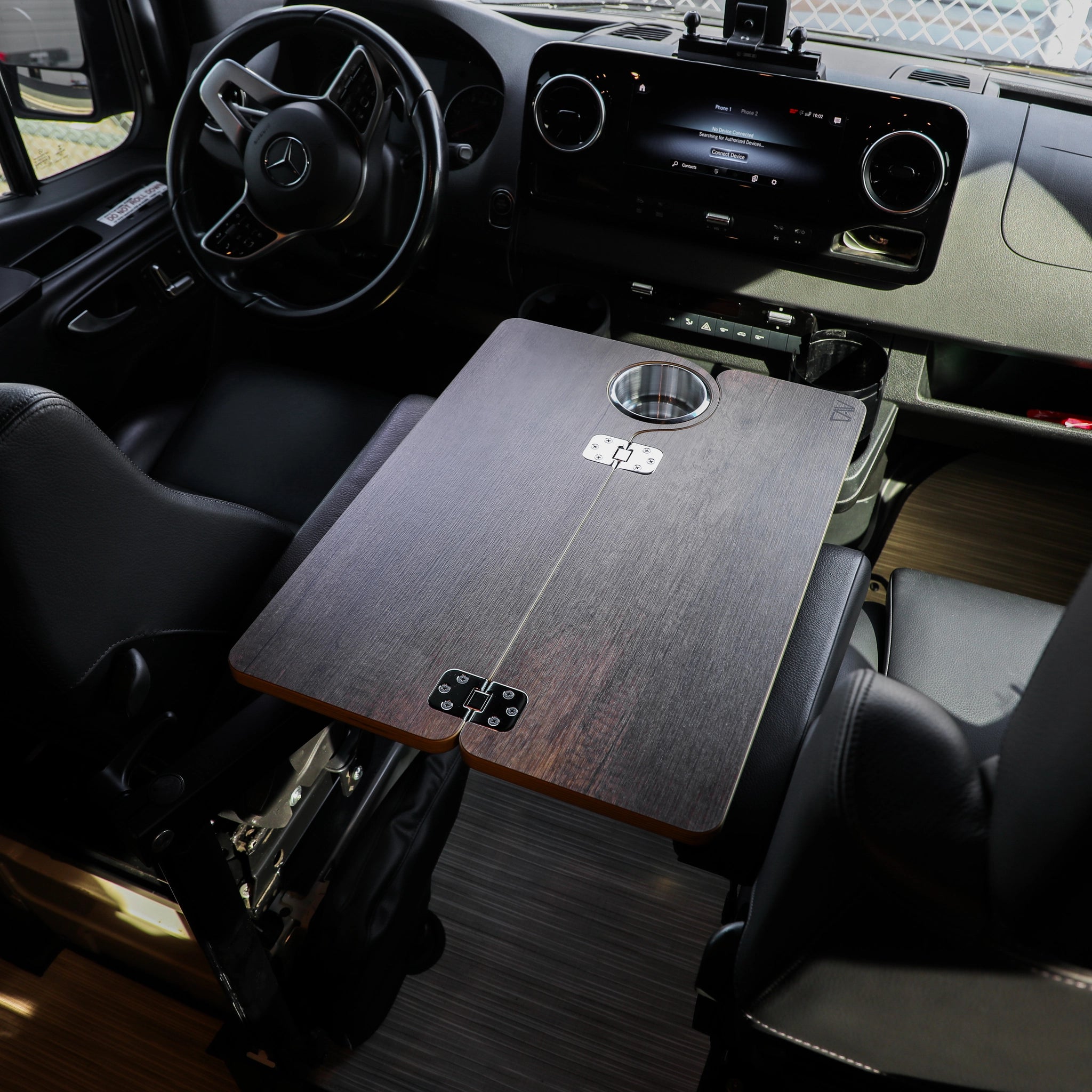 Solo Folding Table Top mounted between driver and passenger seats in a van interior.