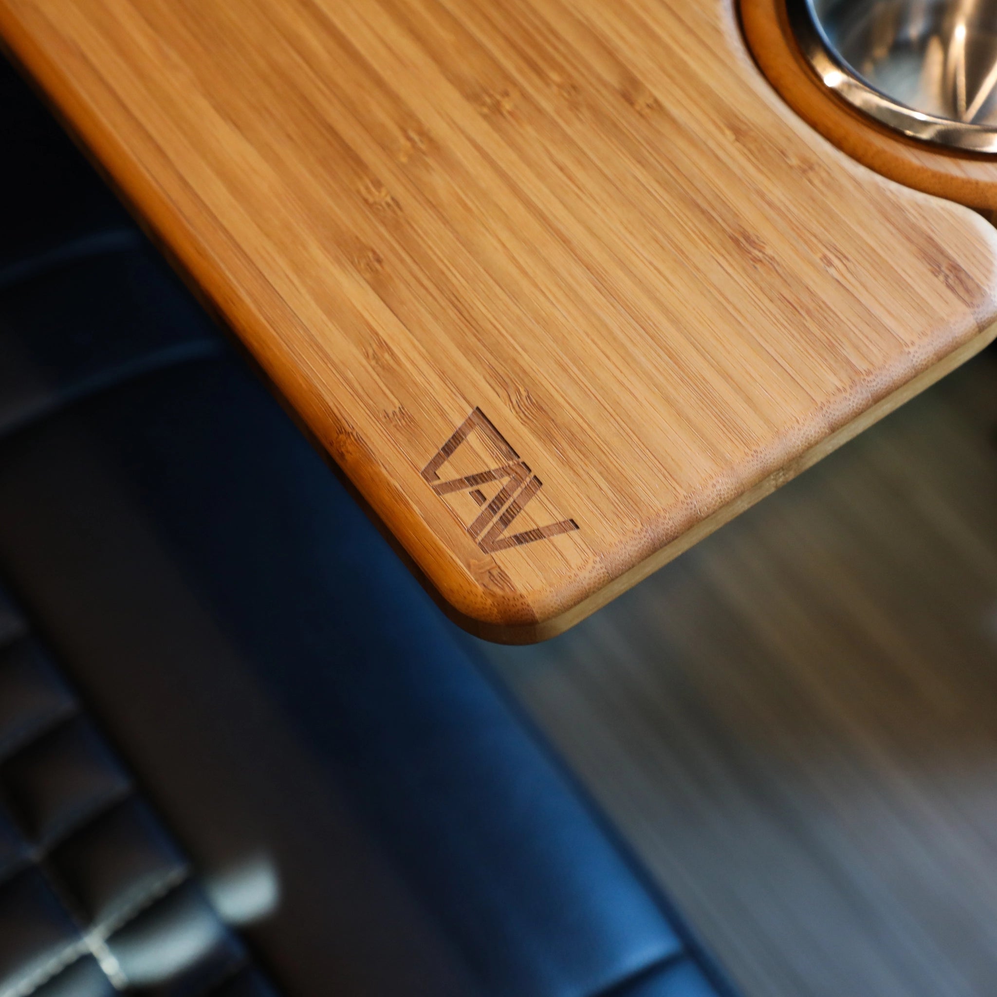Close-up of Solo Folding Table Top installed in a van with bamboo finish and integrated cup holder.