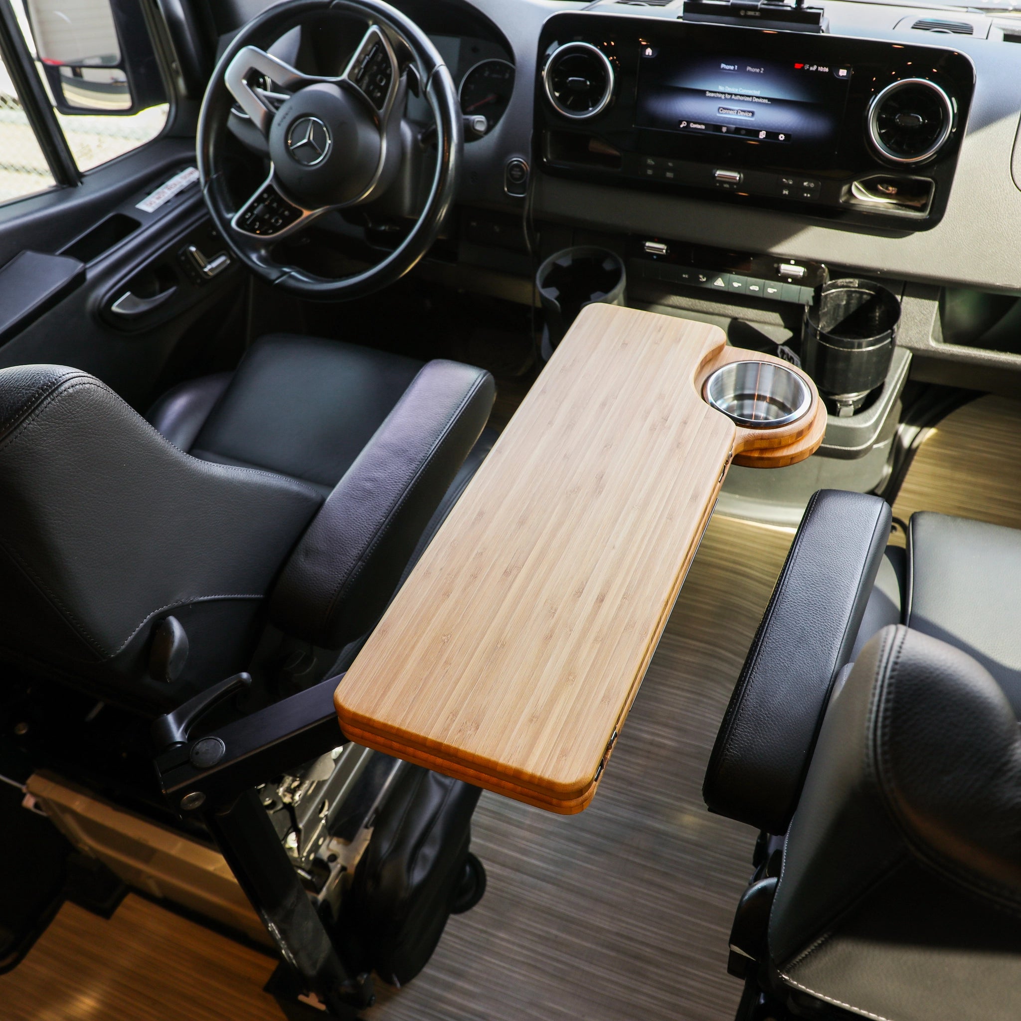Solo Folding Table Top mounted between front seats in a van interior with cup holder visible