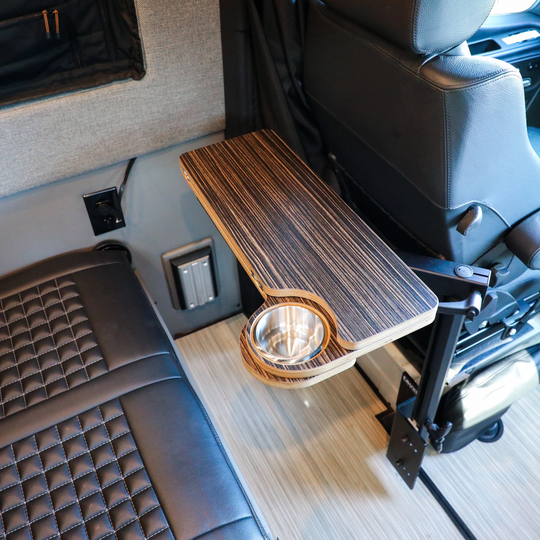 Solo Folding Table Top by CAV mounted beside van seat with integrated cup holder