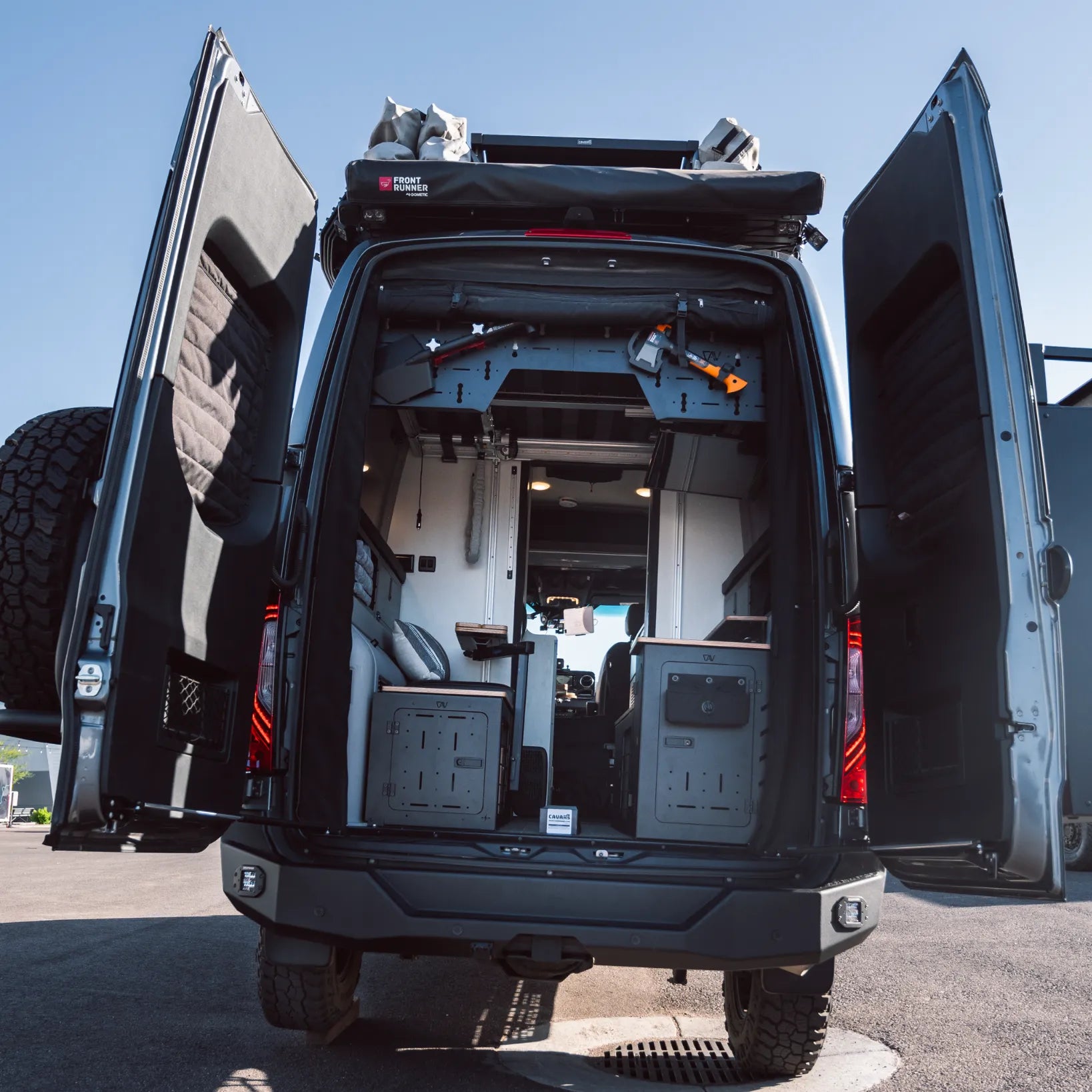 Rear view of an open Revel van showing organized storage, seating, and interior features from the Ultimate Revel Bundle.