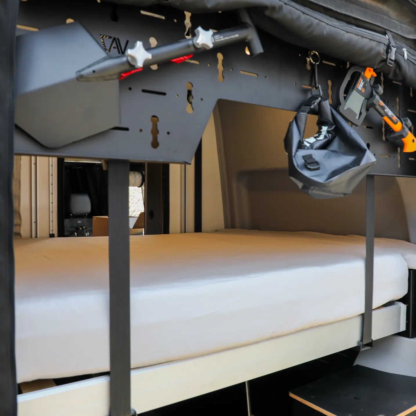 CAV ultra luxe Dream Sheets on a bed inside a modern van interior with overhead storage