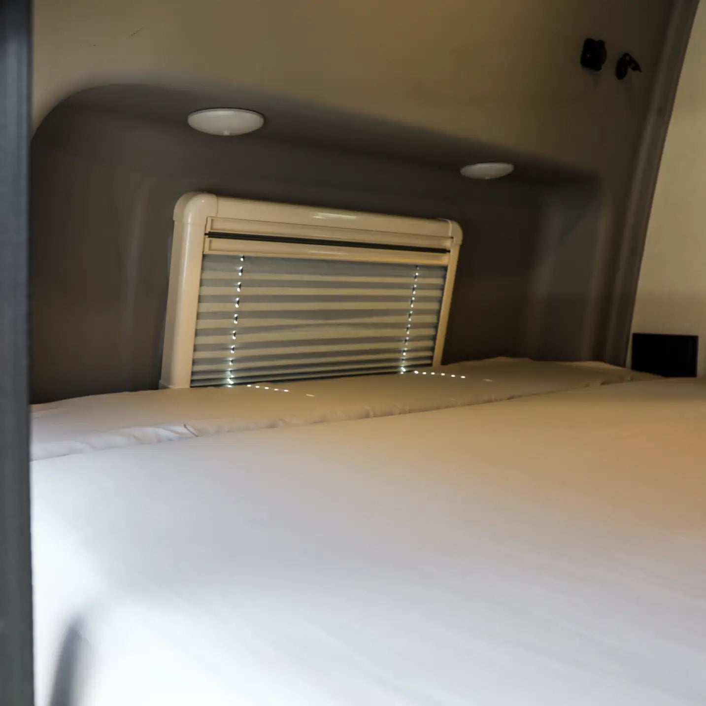 Ultra Luxe Dream Sheets by Revel on a van bed with closed window shade