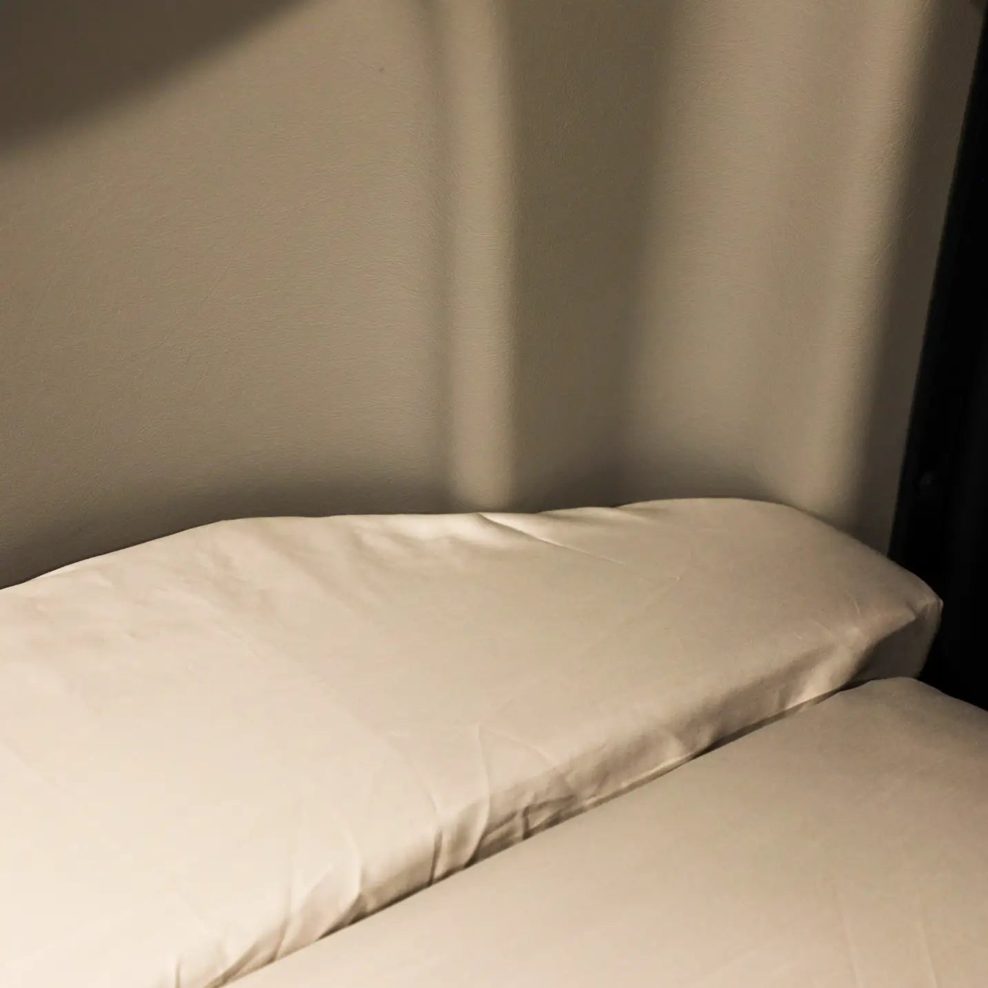 Ultra Luxe Dream Sheets by Revel on a van bed with a light beige finish.