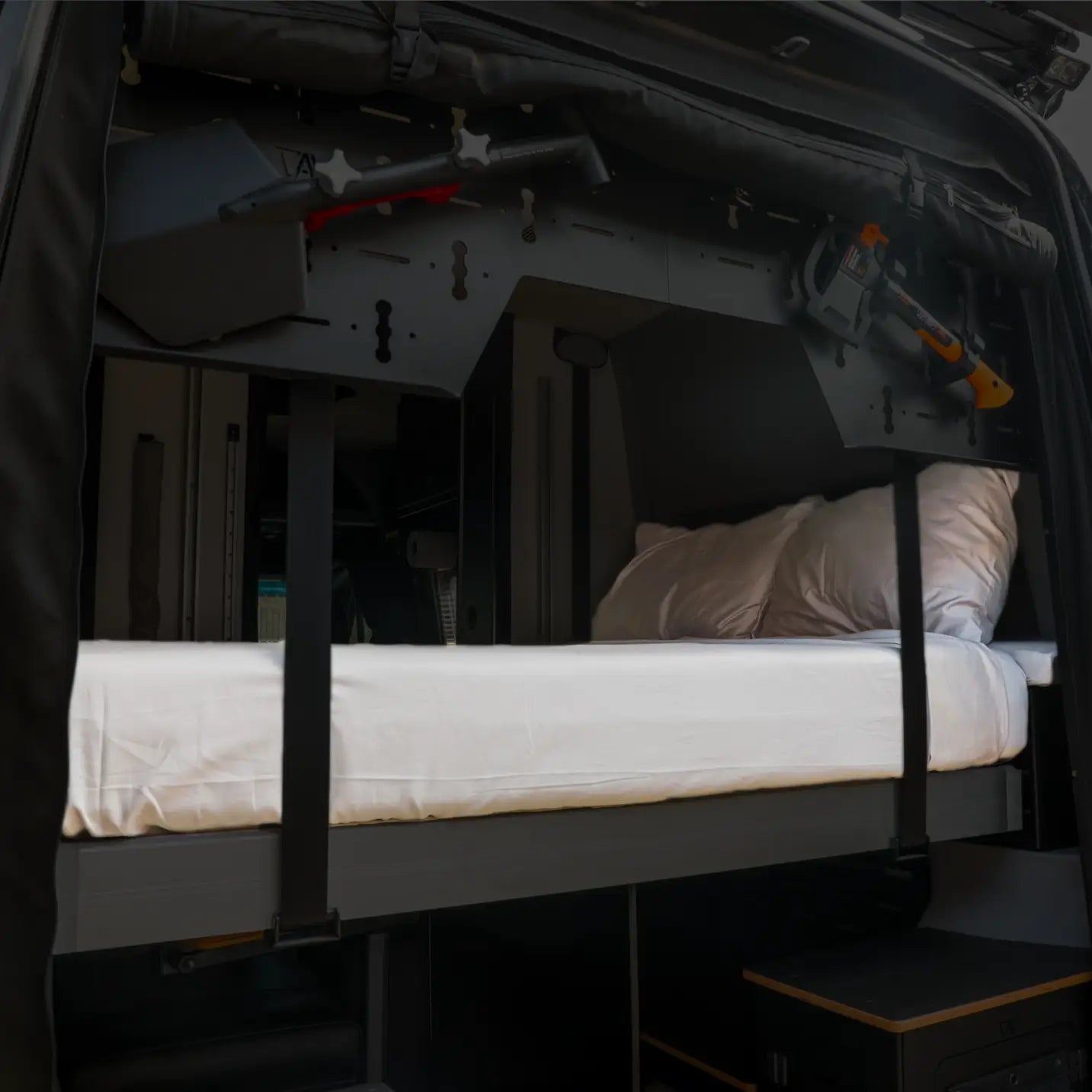 Revel van with mounted gear and white Ultra Luxe Dream Sheets on a fold-down bed