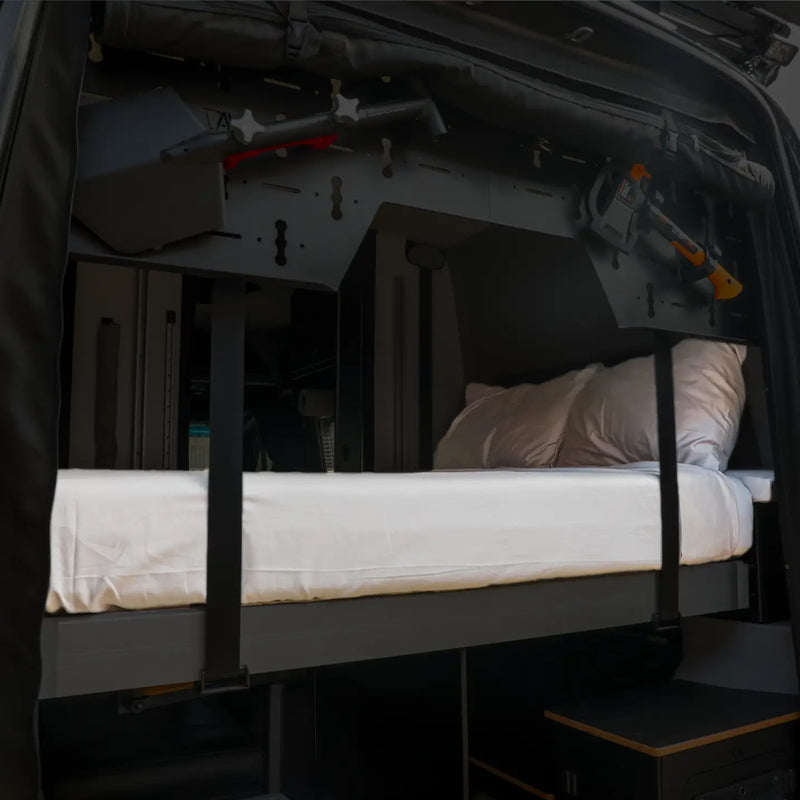 Revel van with mounted gear and white Ultra Luxe Dream Sheets on a fold-down bed