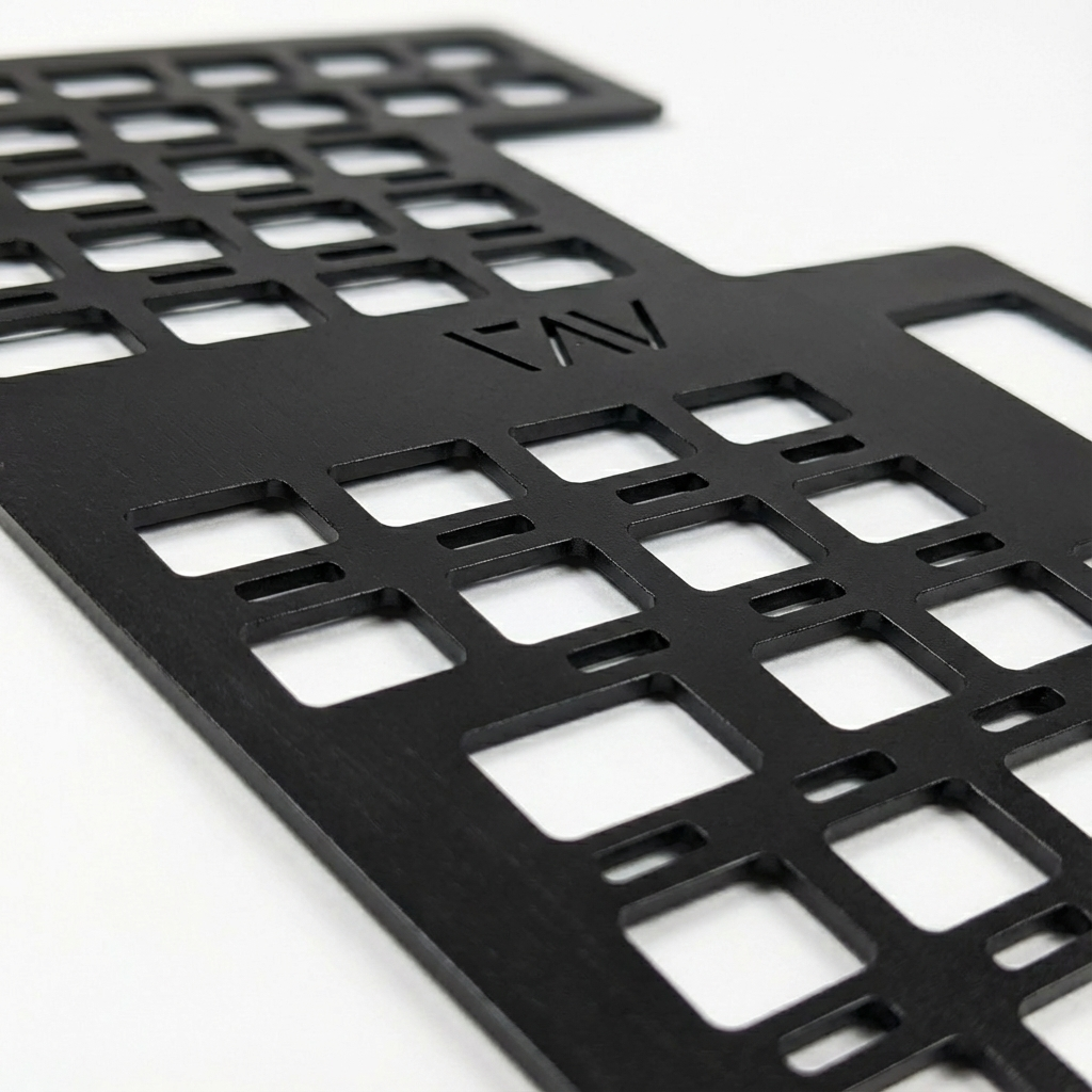 Close-up of black Storyteller Galley MOLLE Panel with cutout grid design and engraved logo.