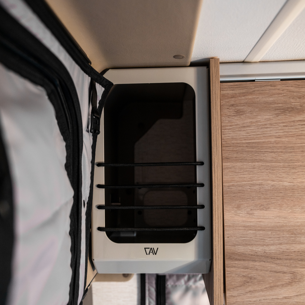 Ekko Cab Cubby by CAV mounted in van interior above wood cabinetry
