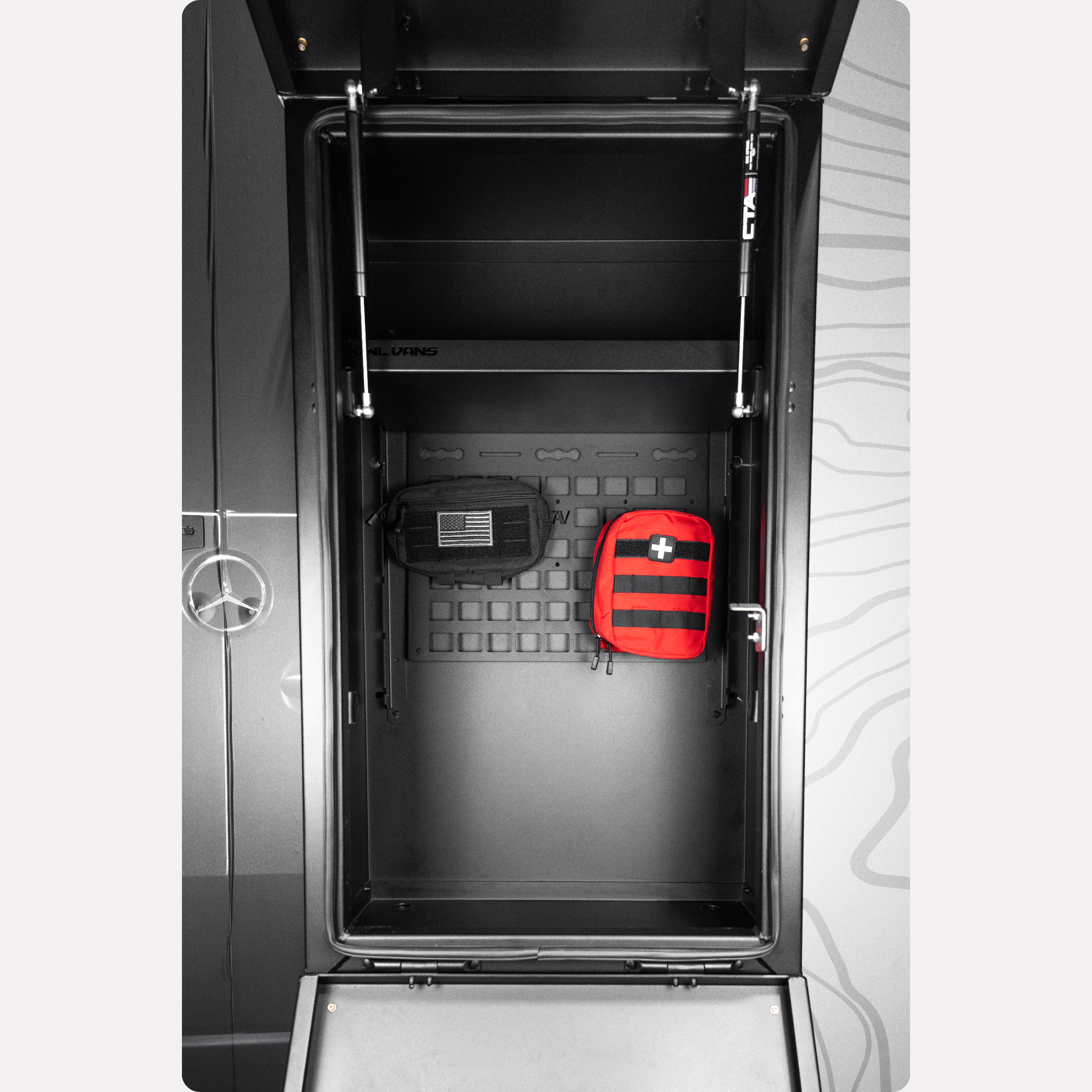 Owl Vans rear storage box with Molly Panel, showing two attached utility pouches inside a van door
