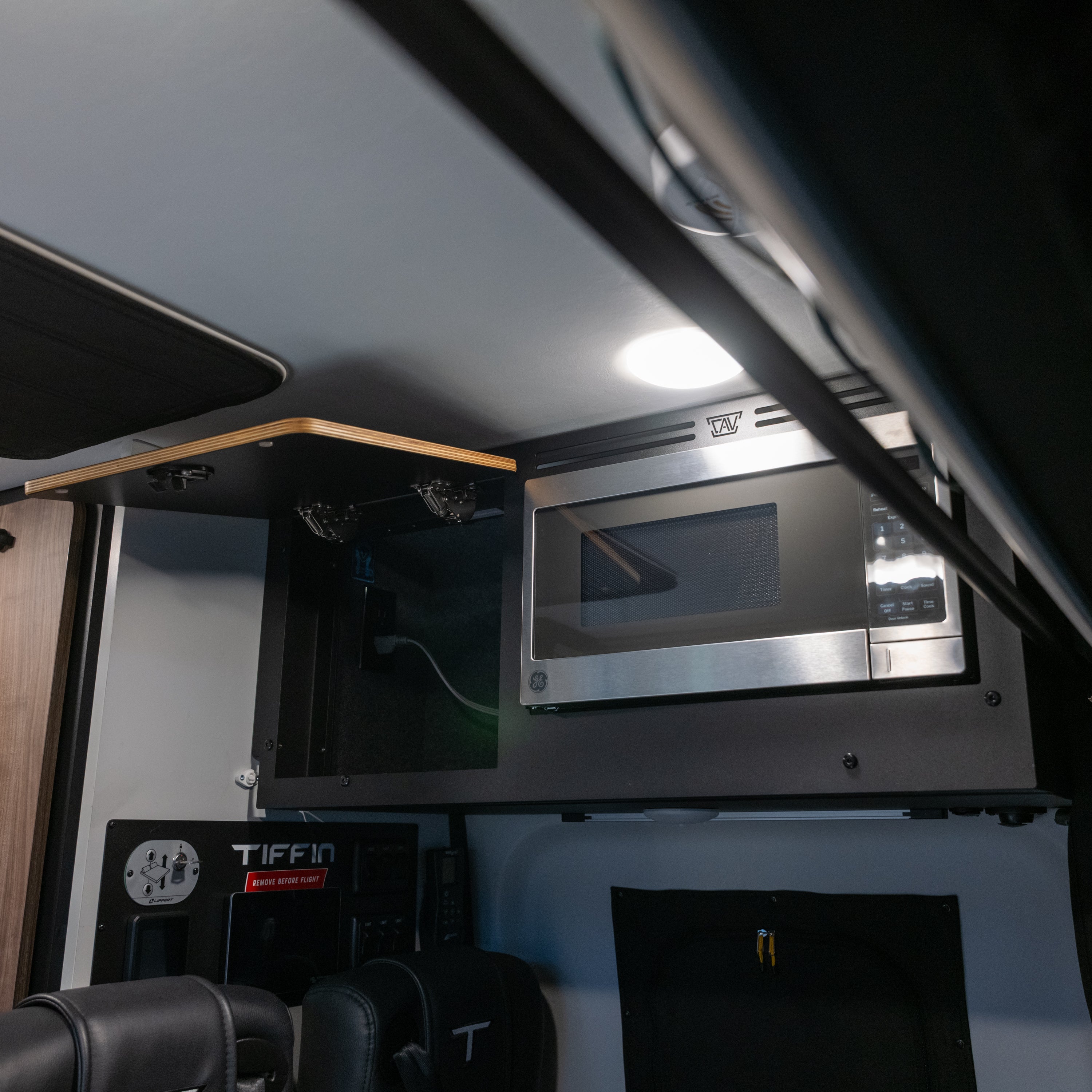 Tiffin GH1 microwave kit installed in upper cabinet of van interior