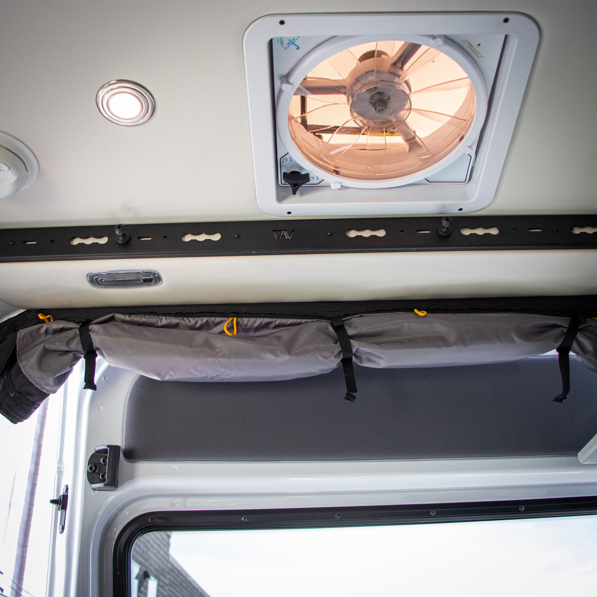Interior of mercedes sprinter van storyteller mode 2023 with black overhead slider door l track pro showing l track hook above sliding door and bug screen wrapped up in view