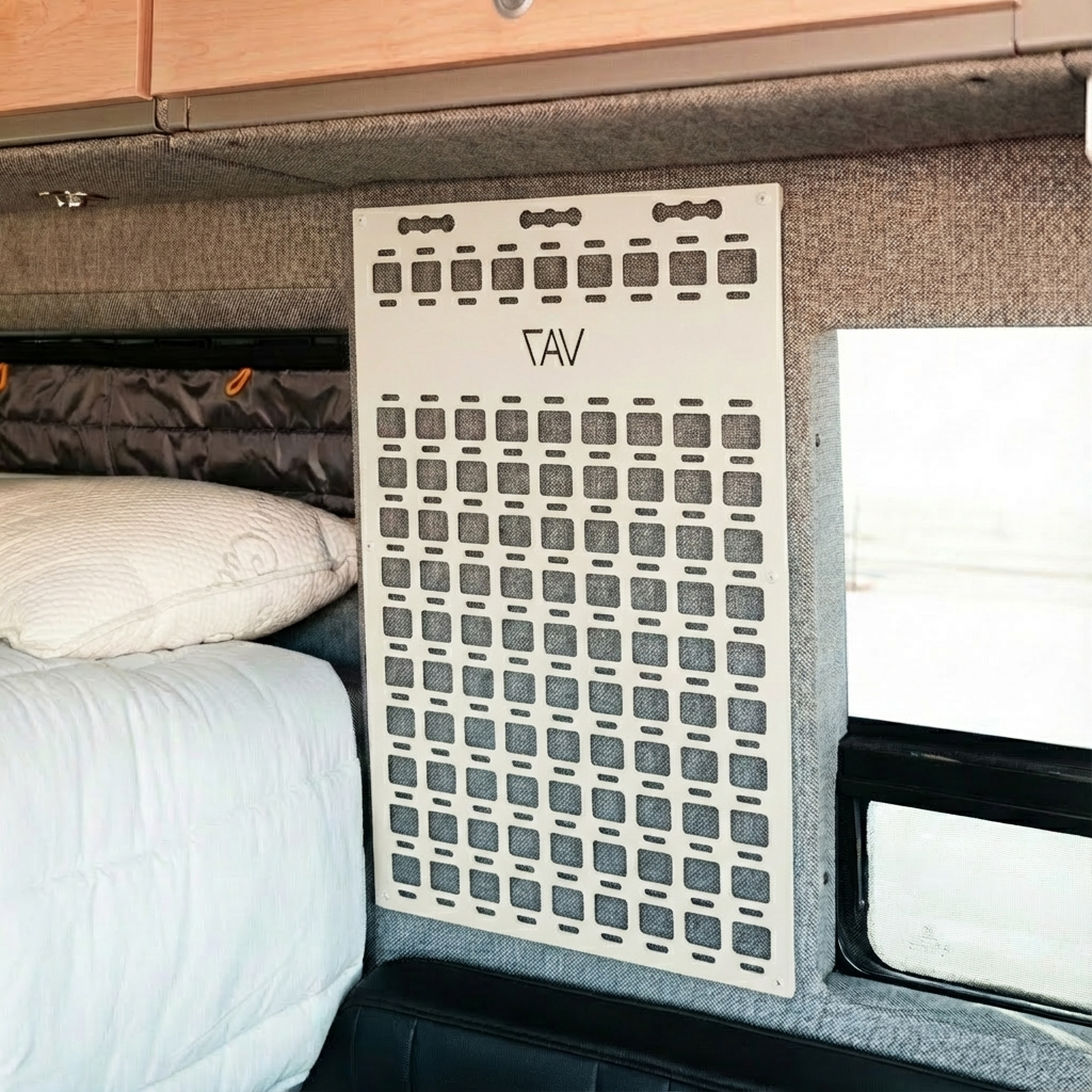 CAV Storyteller Shower MOLLE panel mounted on van interior wall near bed and window.