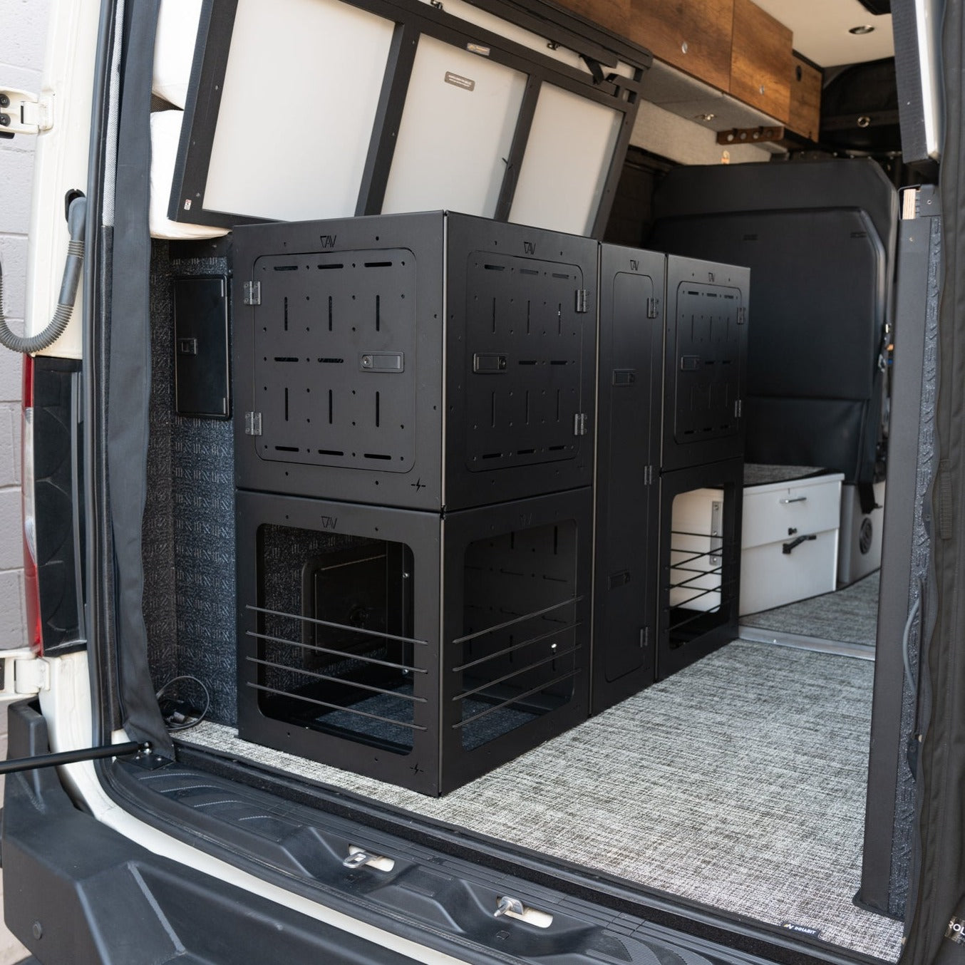 GSS PRO garage storage system installed in rear of Storyteller van with black metal compartments.