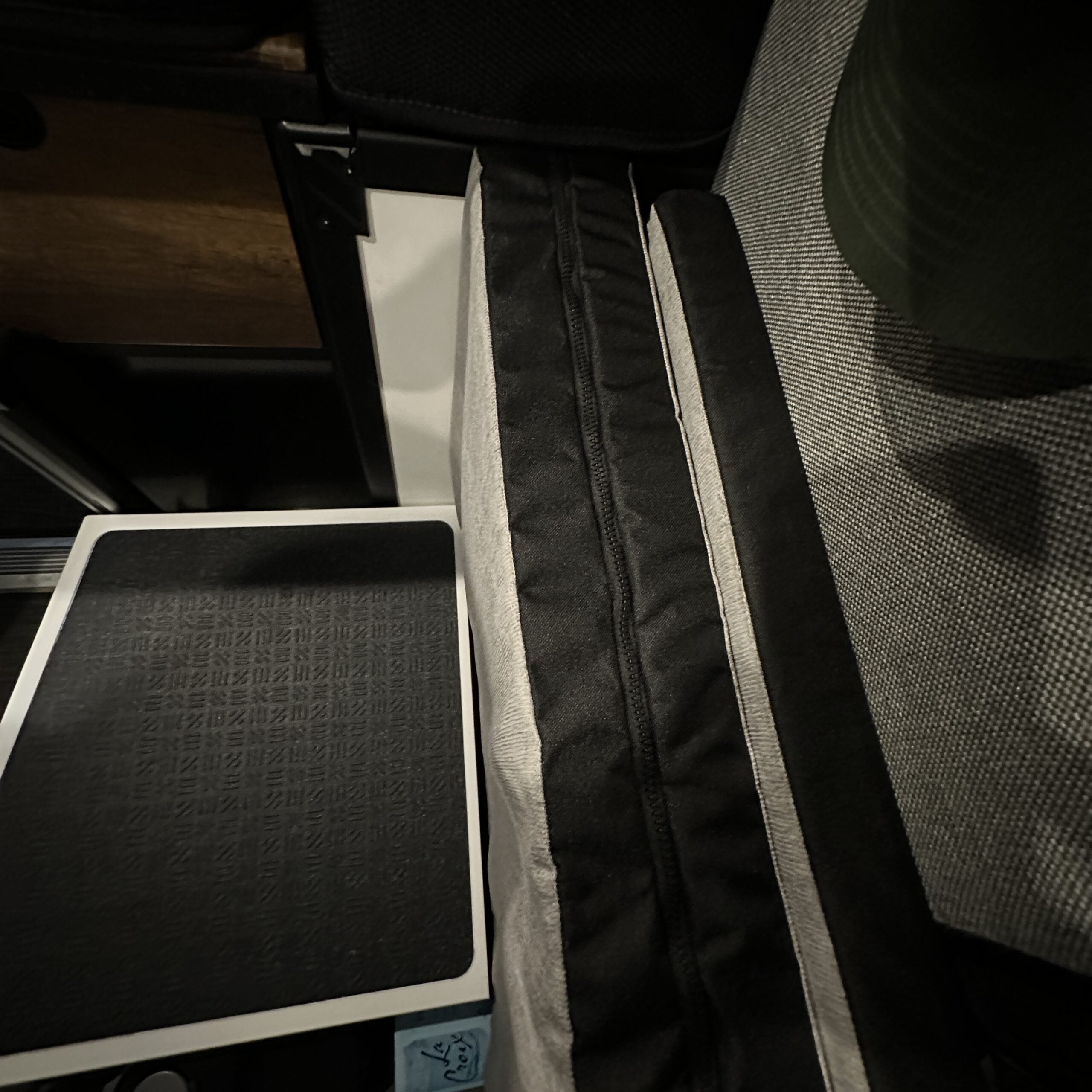 Groove Lounge Mattress Topper for Storyteller van, folded and stored along side cushion.